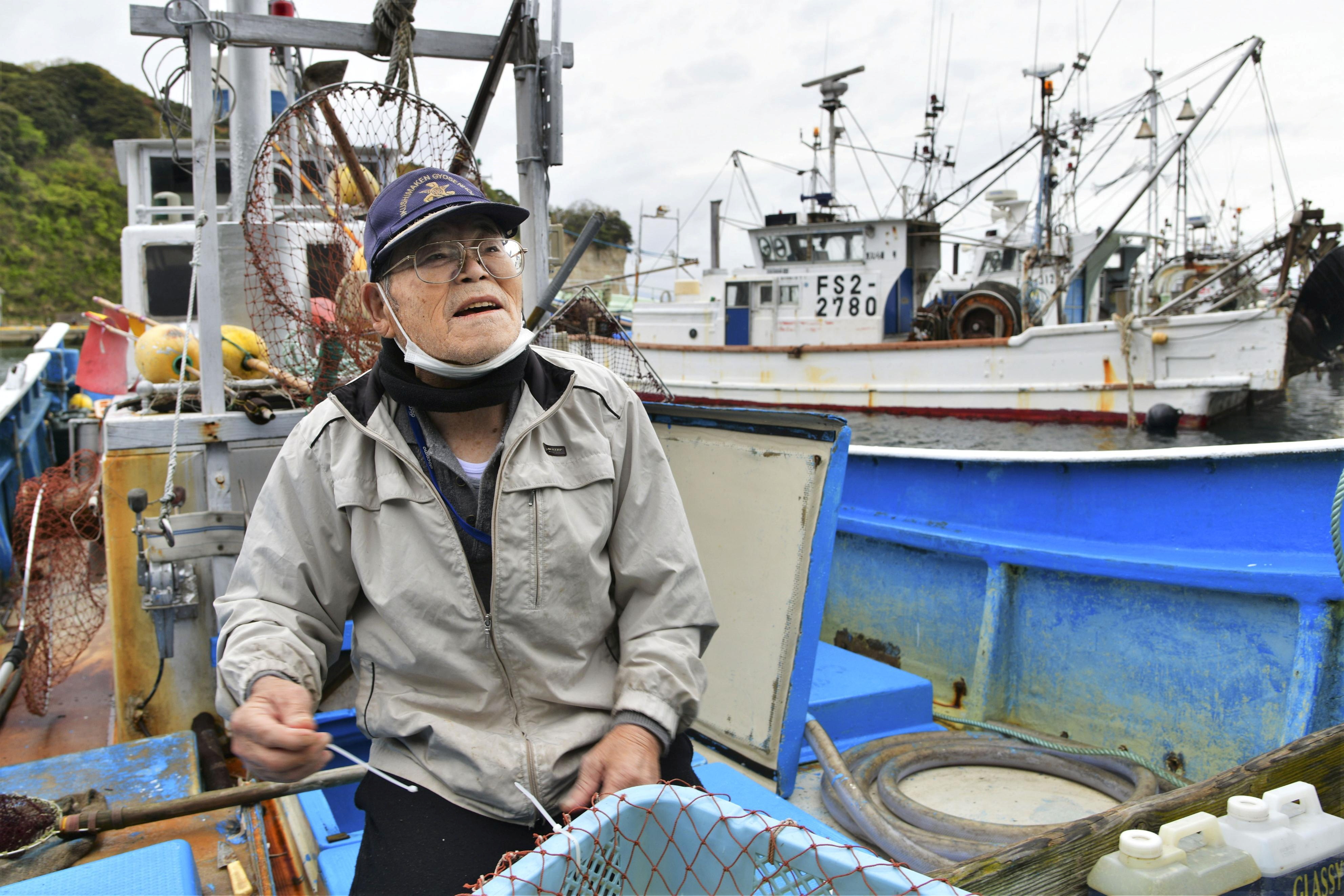 A fisherman is seen on the boat after a fishing operation at a port in Iwaki, Fukushima prefecture