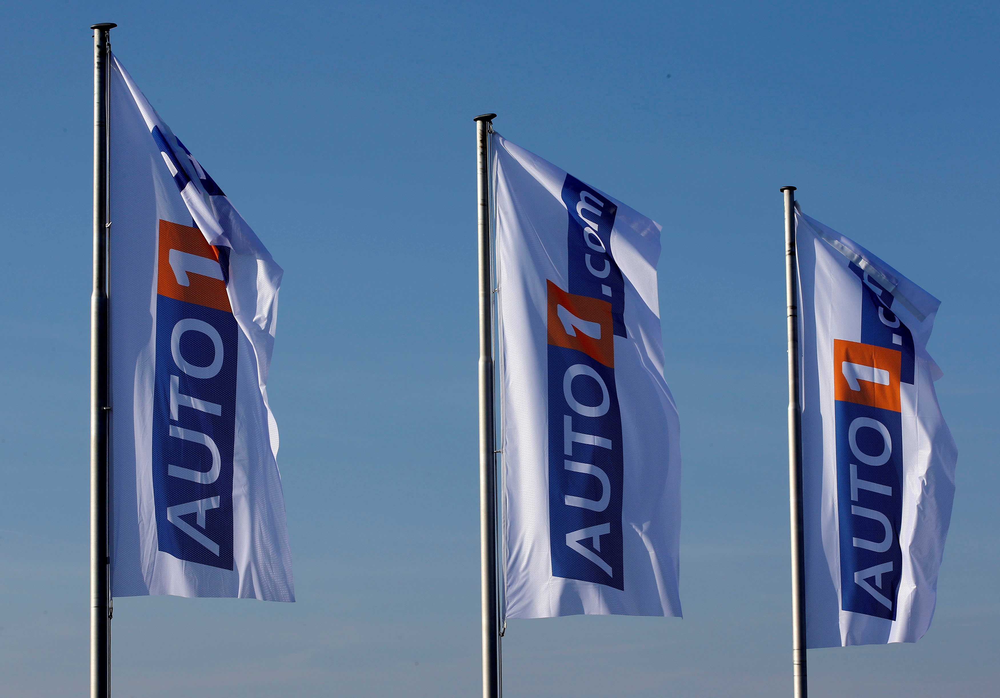 Flags bearing the AUTO1 logo pictured at the company grounds in Zoerbig, Germany
