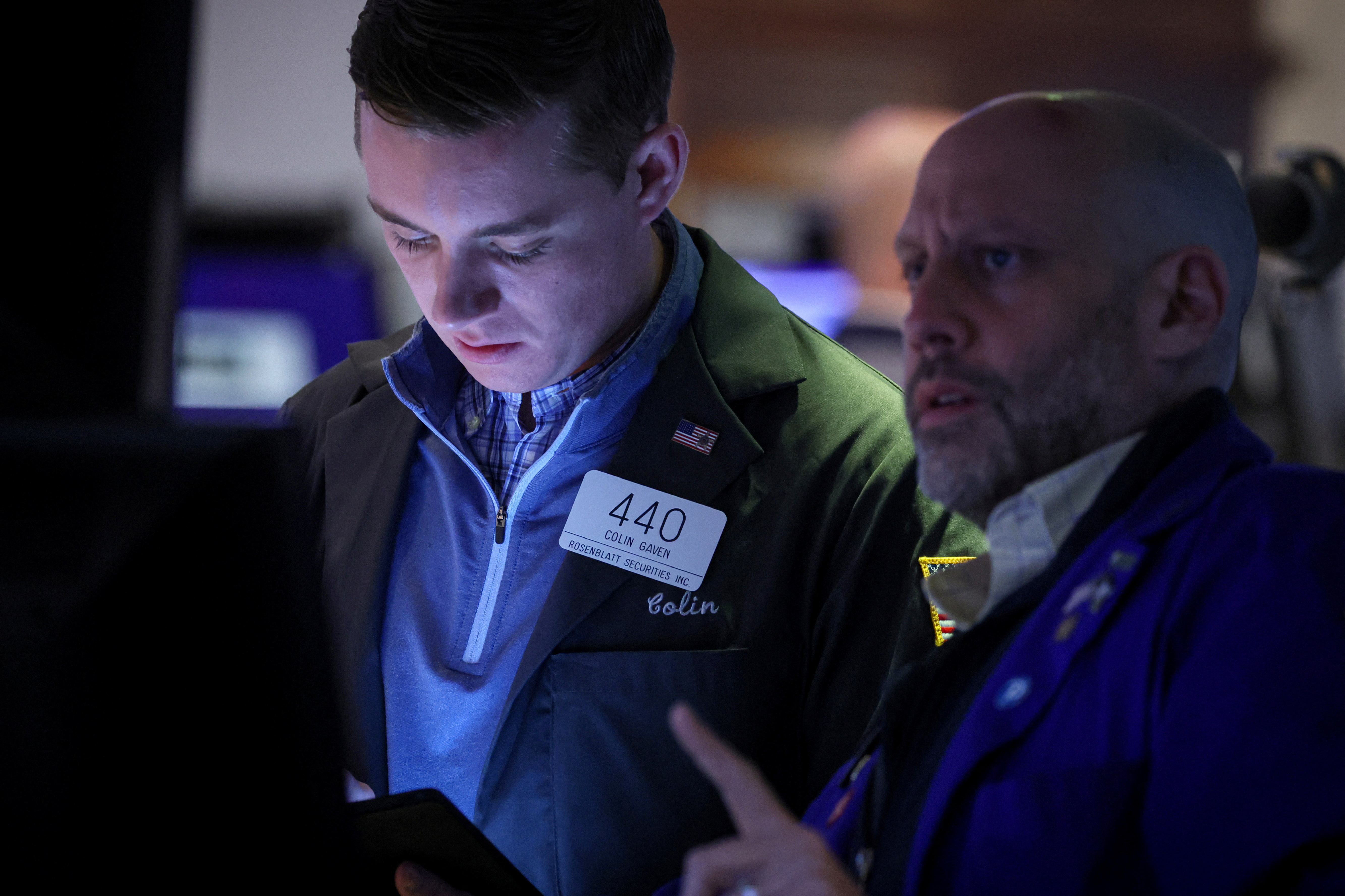 Traders work on the floor of the NYSE in New York