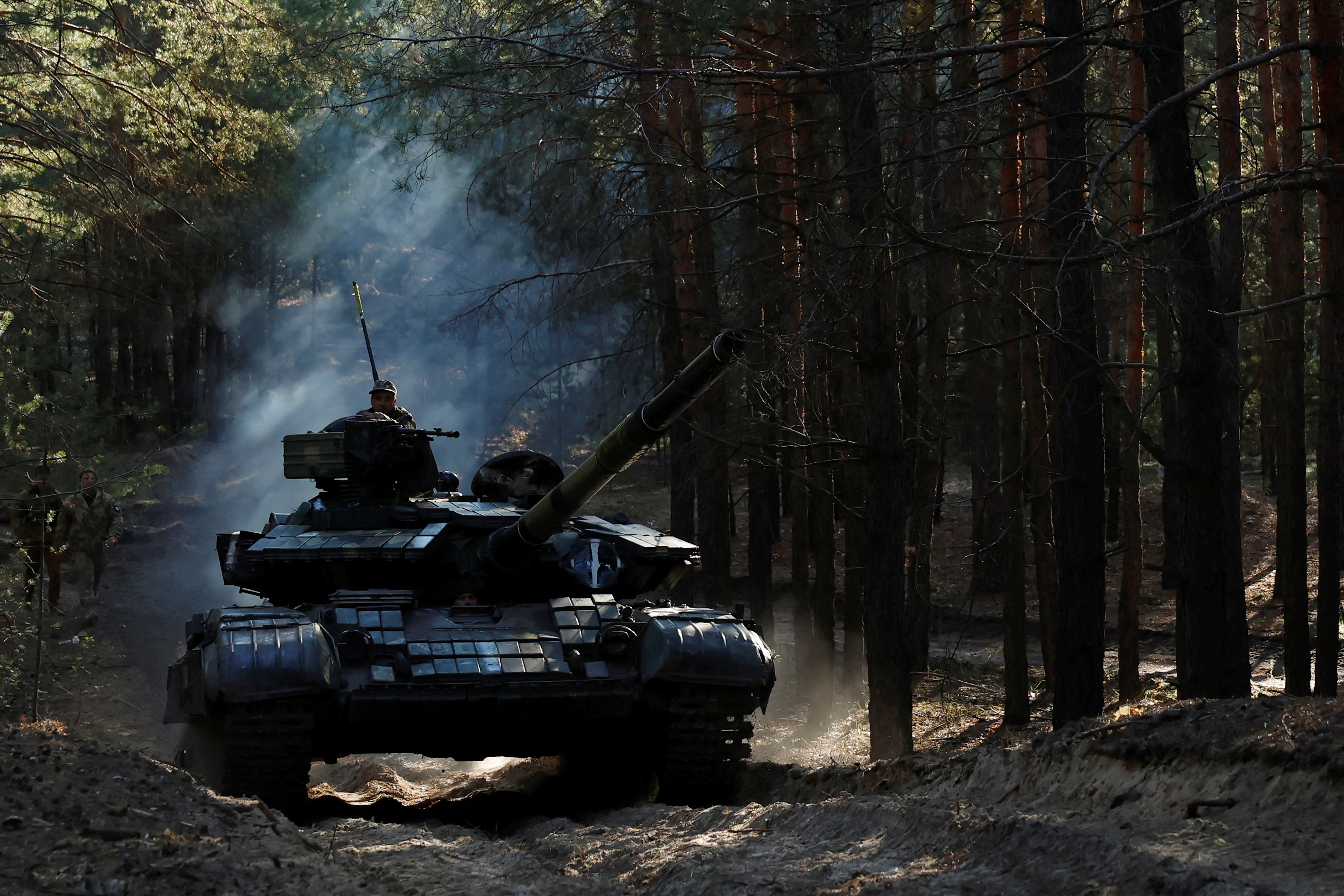 Ukrainian soldiers re-fit captured Russian tanks, in Kupiansk region