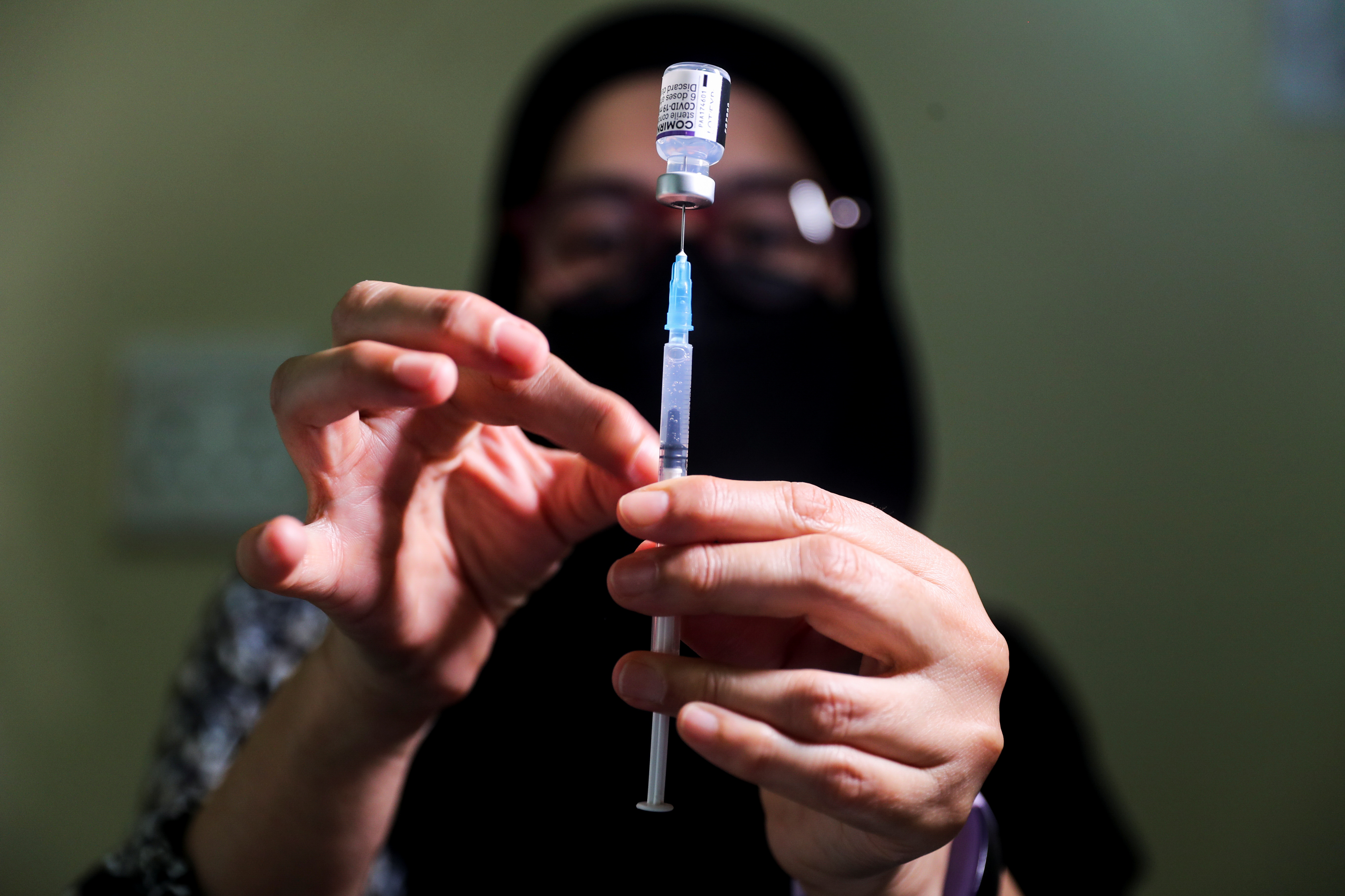 Pharmacist prepares a dose of the coronavirus disease (COVID-19) Pfizer vaccine, in Johannesburg