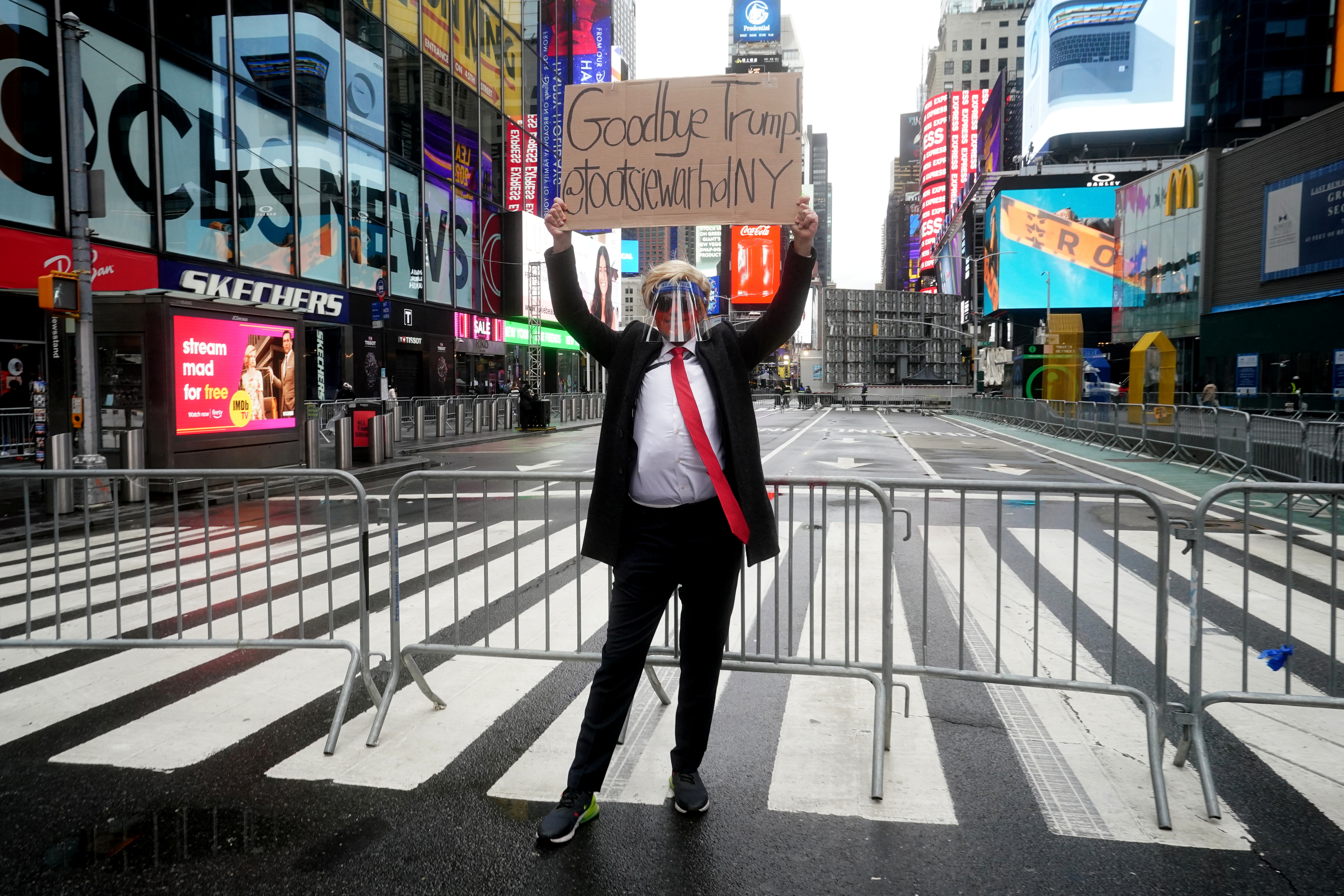 A Donald Trump impersonator poses for photos in Times Square ahead of New Year's Eve