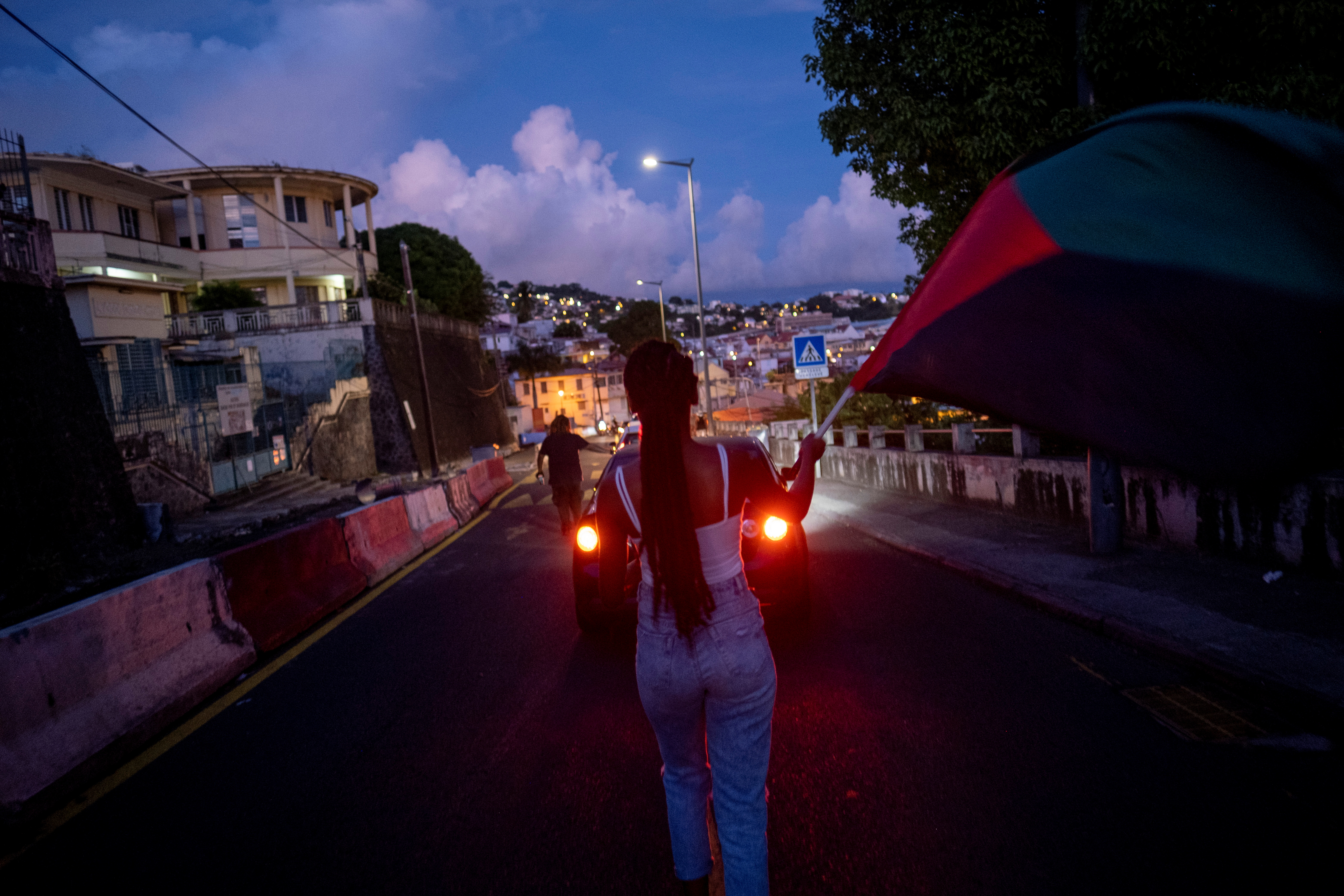 People participate in a peaceful protest against the government's coronavirus disease (COVID-19) protocols through downtown Fort de France after the unrest triggered by these curbs, which have already rocked the nearby island of Guadeloupe, in Fort-De-France, Martinique November 28, 2021. REUTERS/Ricardo Arduengo
