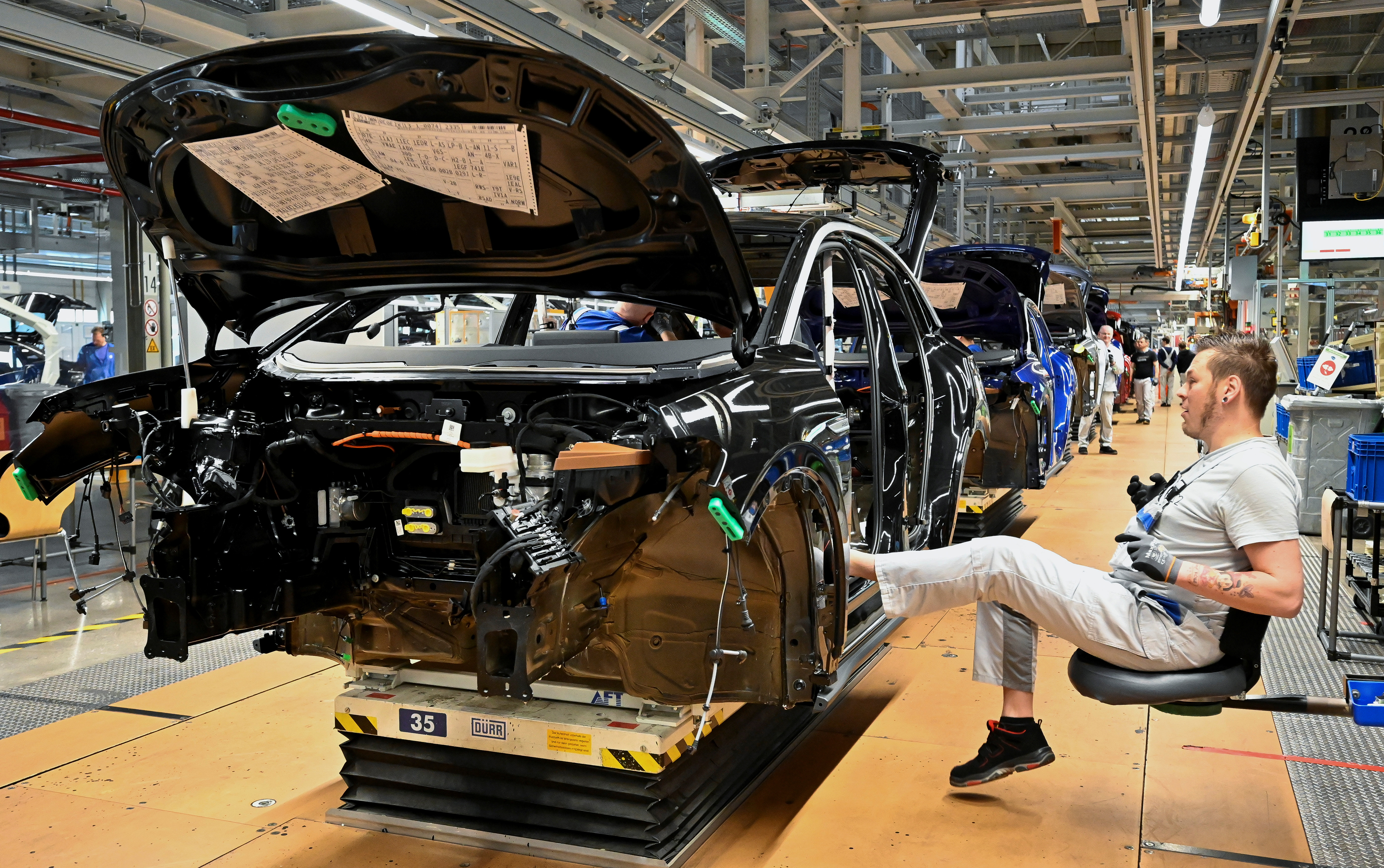 Technicians work at the production line for electric car models of the Volkswagen Group, in Zwickau