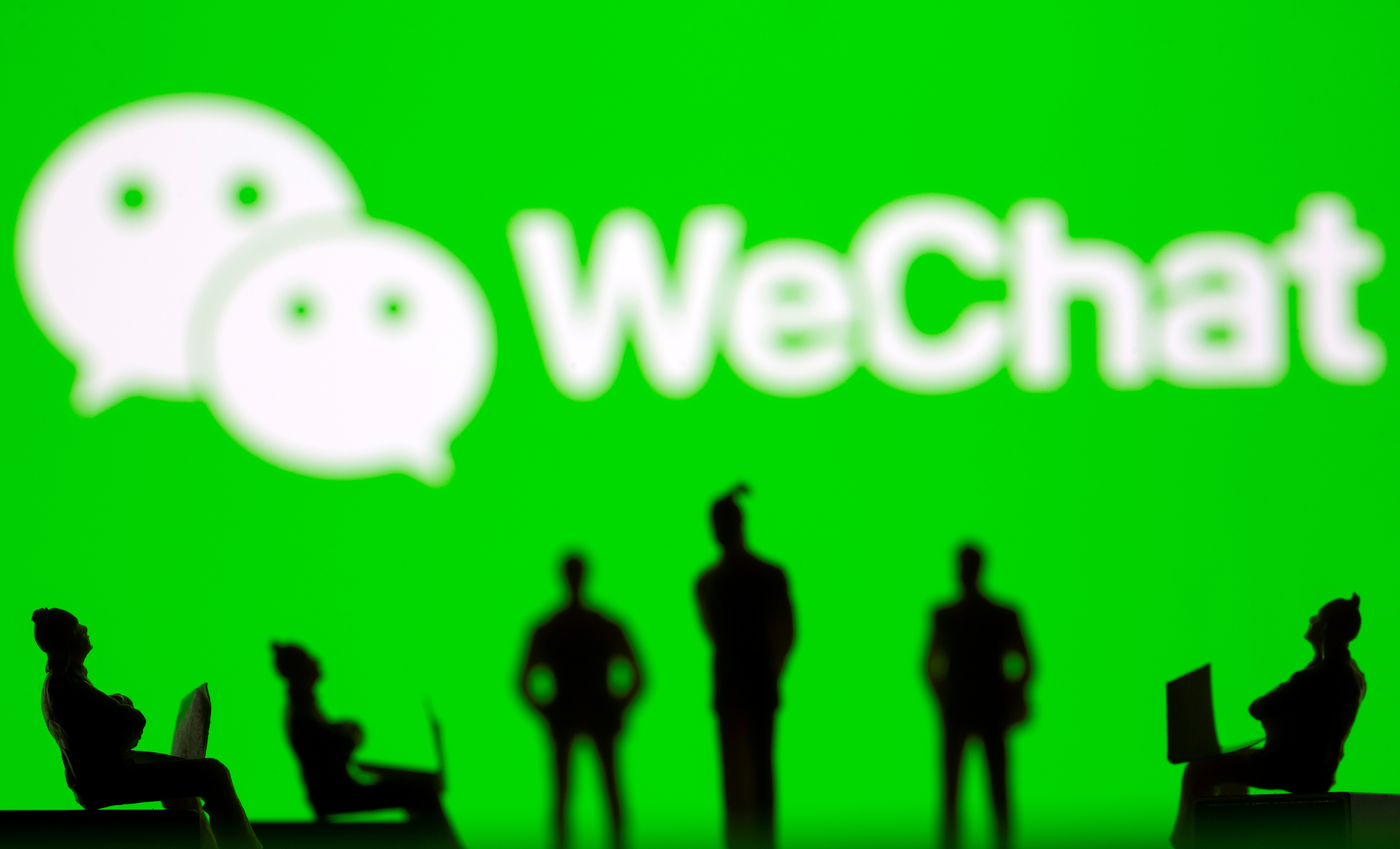Small toy figures are seen in front of WeChat logo in this illustration picture taken March 15, 2021. REUTERS/Dado Ruvic/Illustration/File Photo