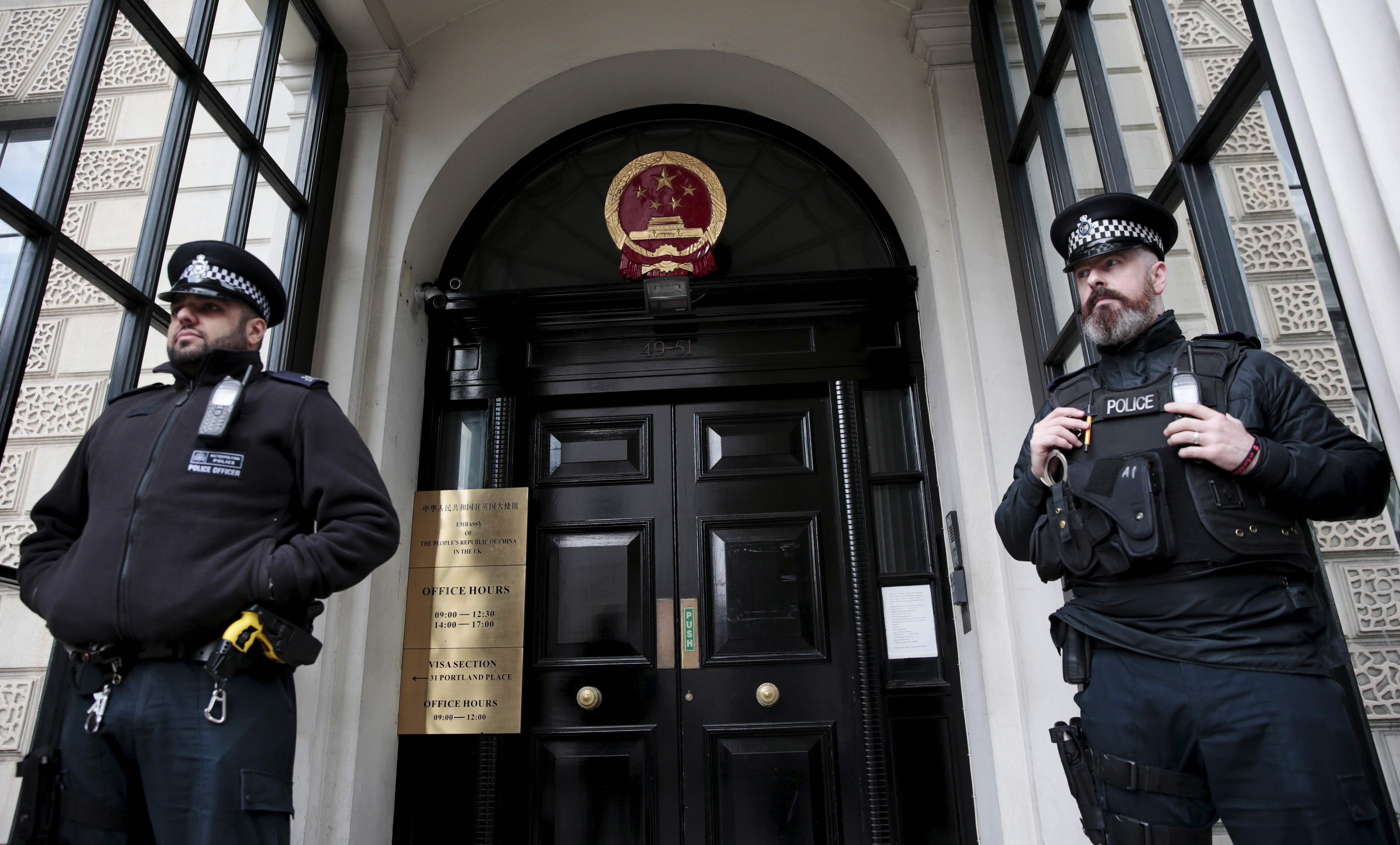Policemen stand guard outside the Chinese Embassy in London, Britain