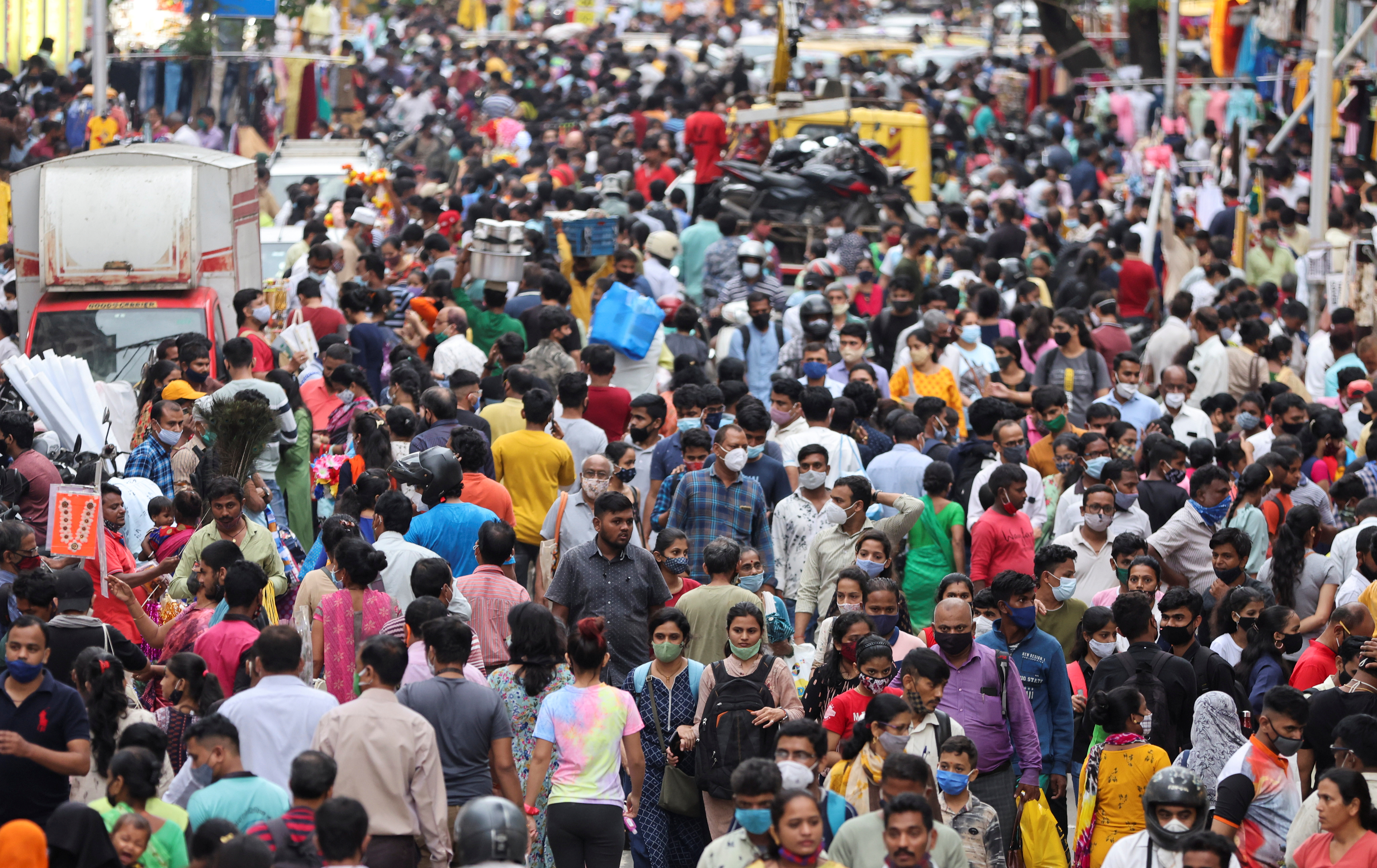 People walk in a crowded market amidst the spread of the coronavirus disease (COVID-19) in Mumbai