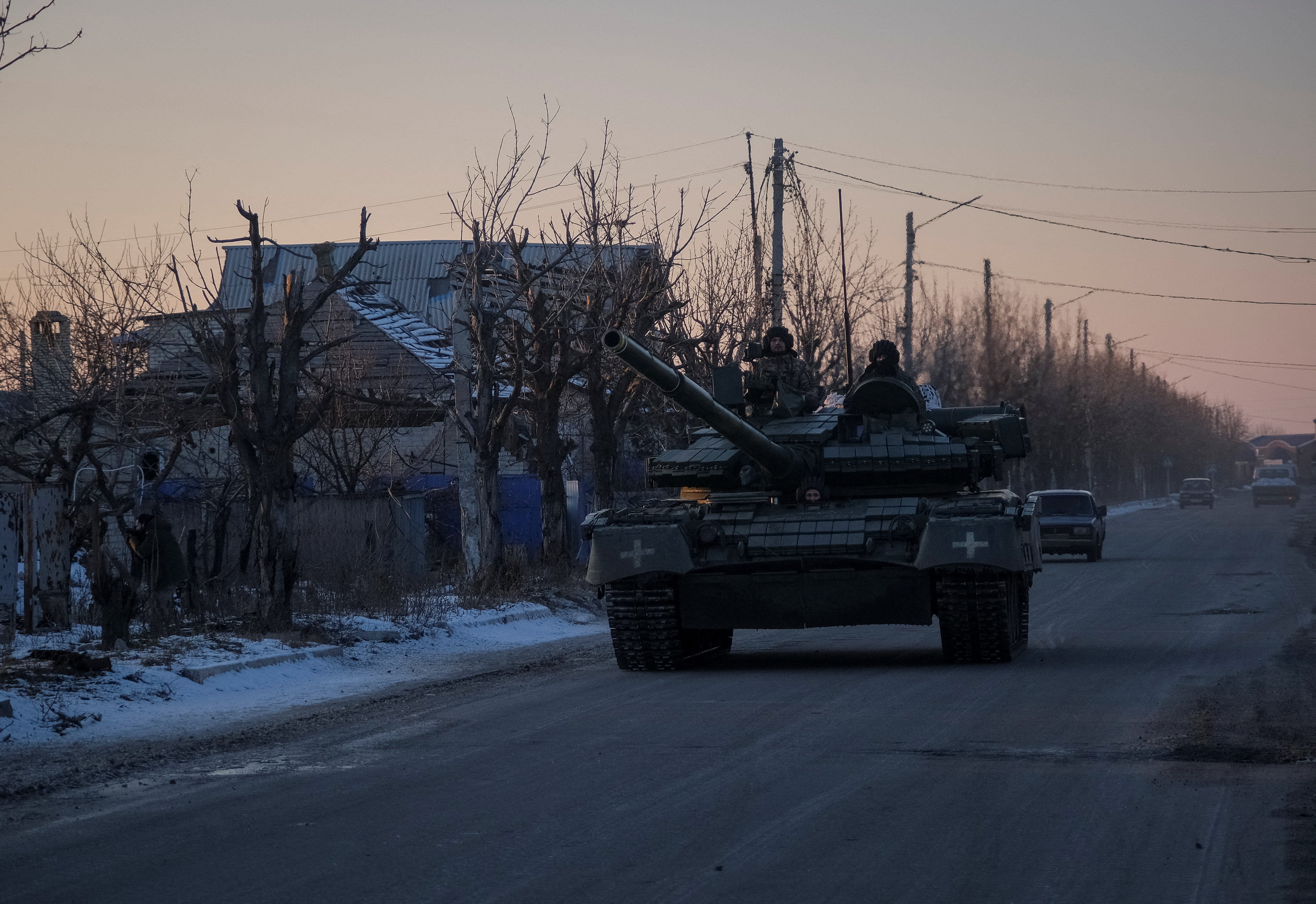 Ukrainian service members ride a tank near Lyman