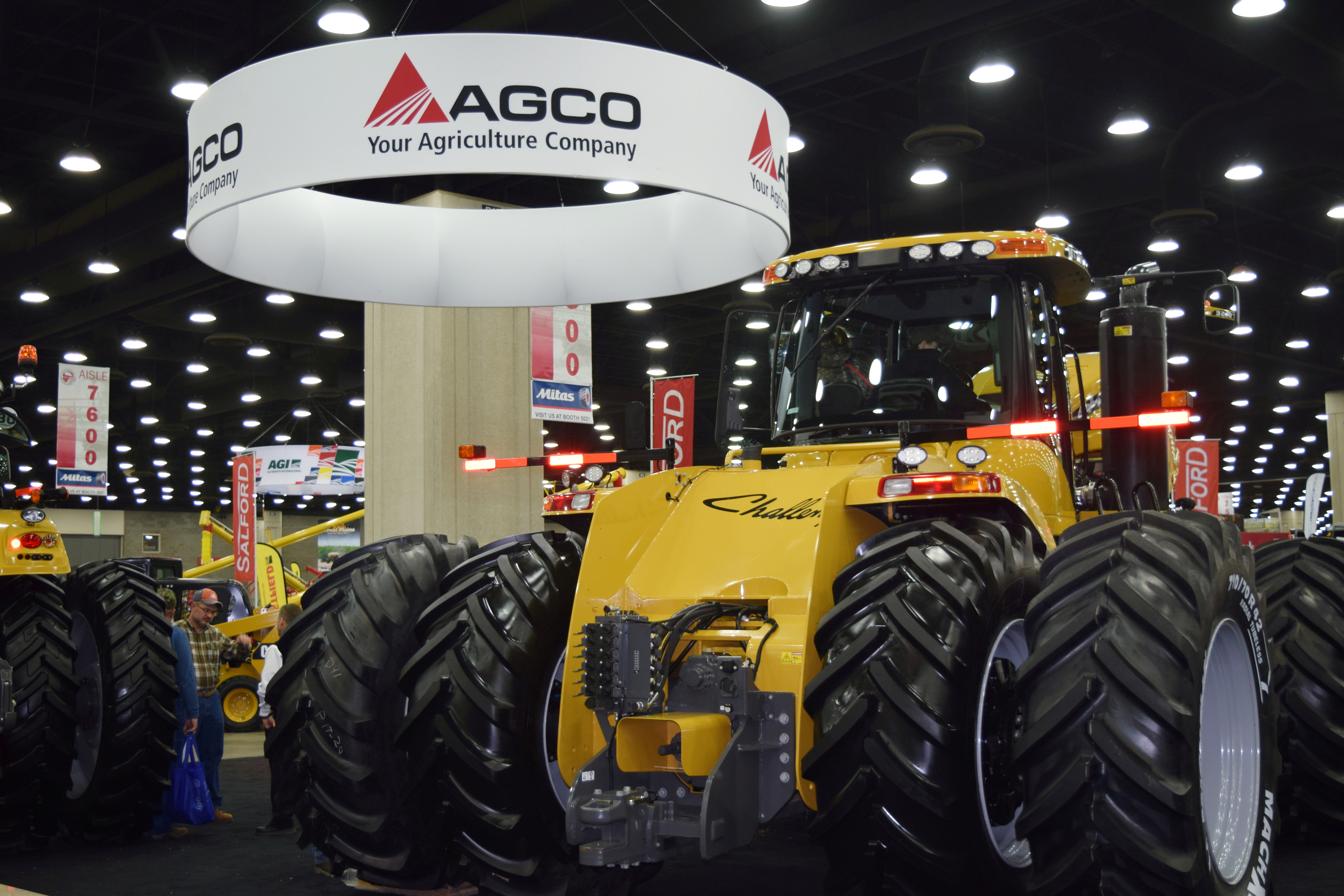 People look at AGCO equipment as they attend National Farm Machinery show in Louisville