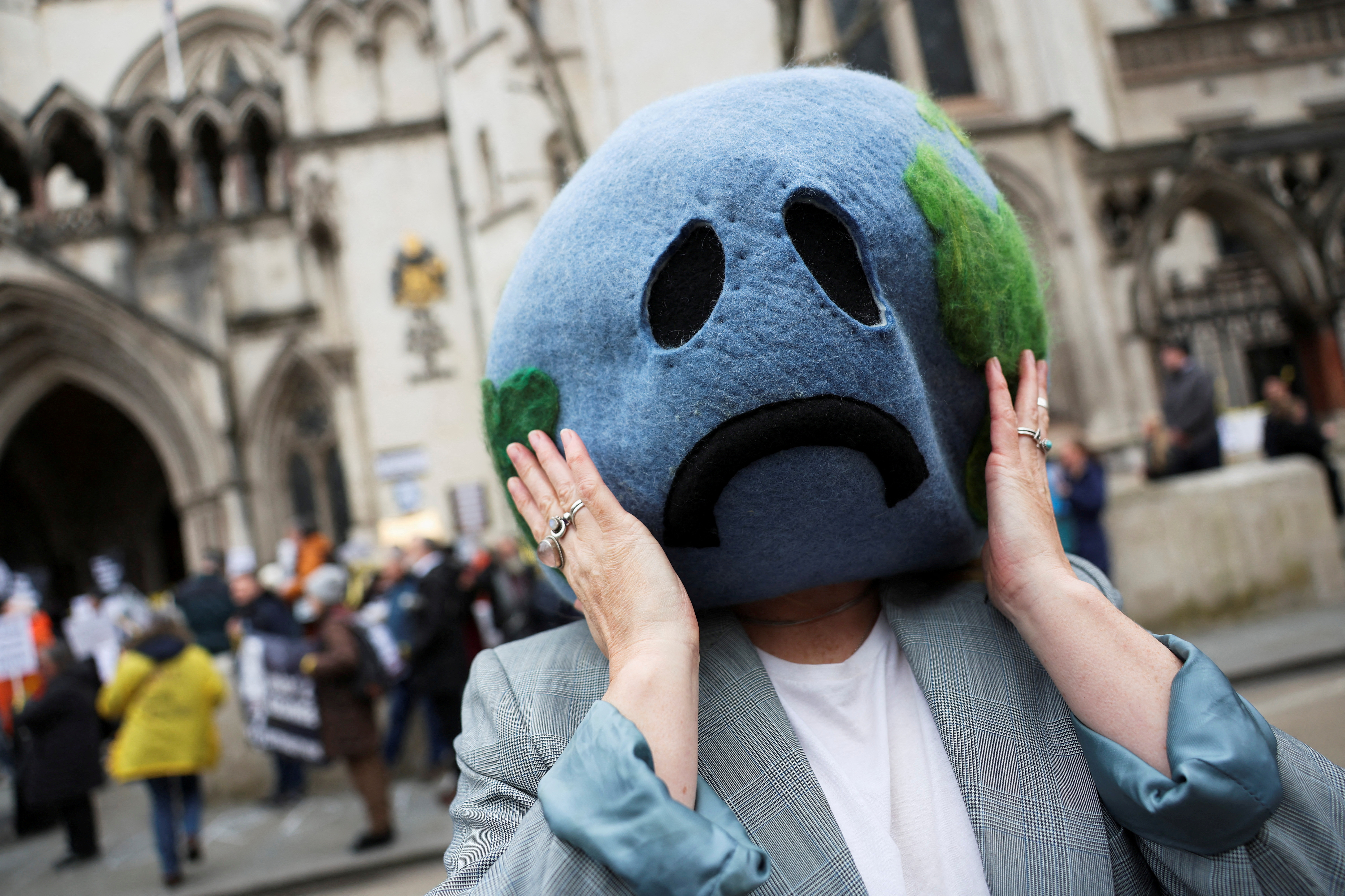 Climate activist demonstrates outside the high court in London