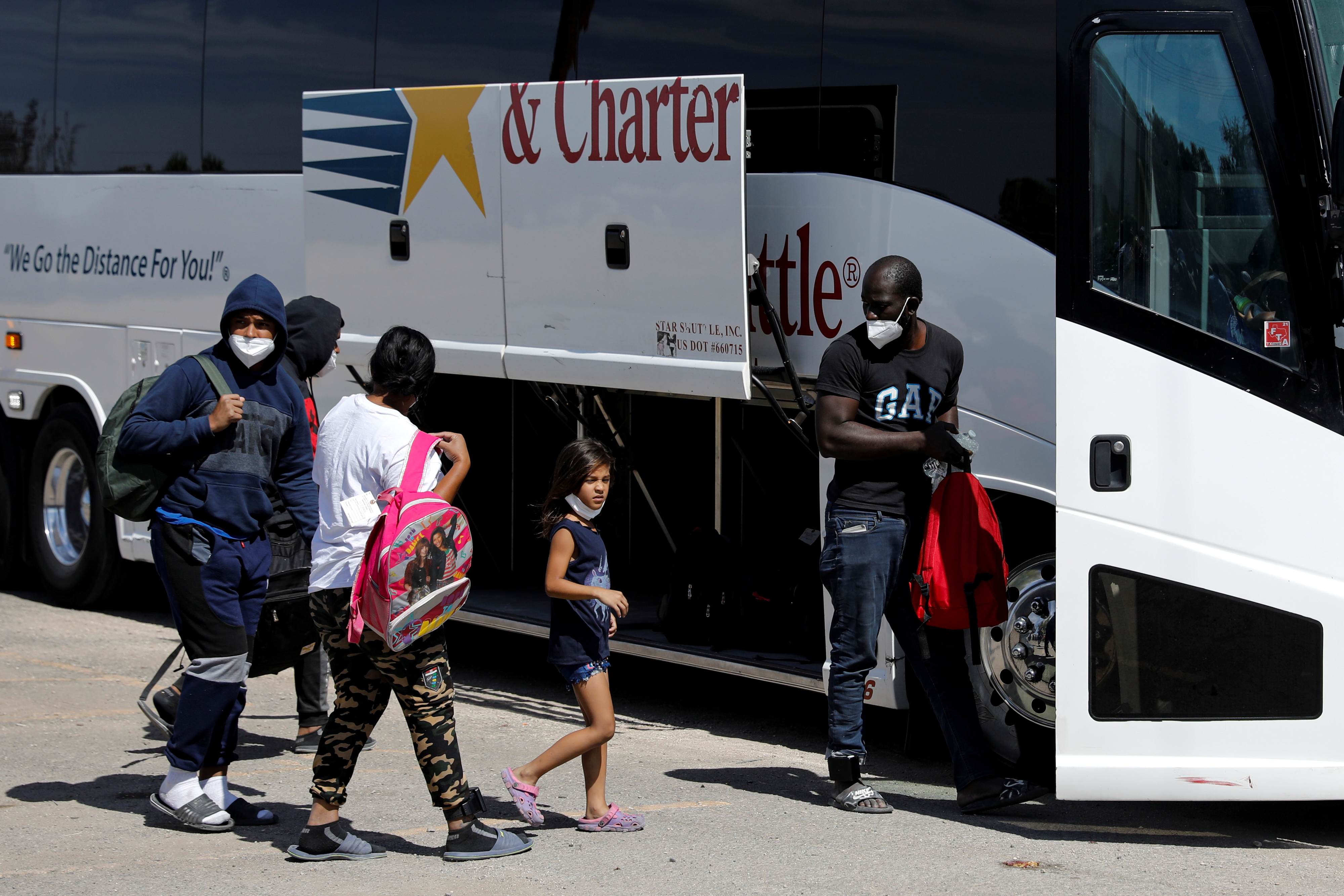 Migrants seeking asylum in the U.S. board a bus to Houston from Val Verde Border Humanitarian Coalition after being released from U.S. Customs and Border Protection, in Del Rio, Texas, U.S., September 22, 2021. REUTERS/Marco Bello