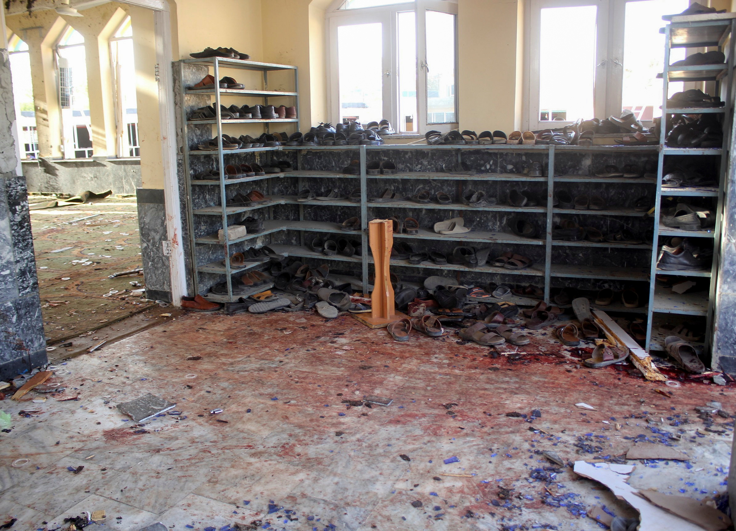 Shoes and bloodstains are seen inside a mosque after a blast, in Kunduz