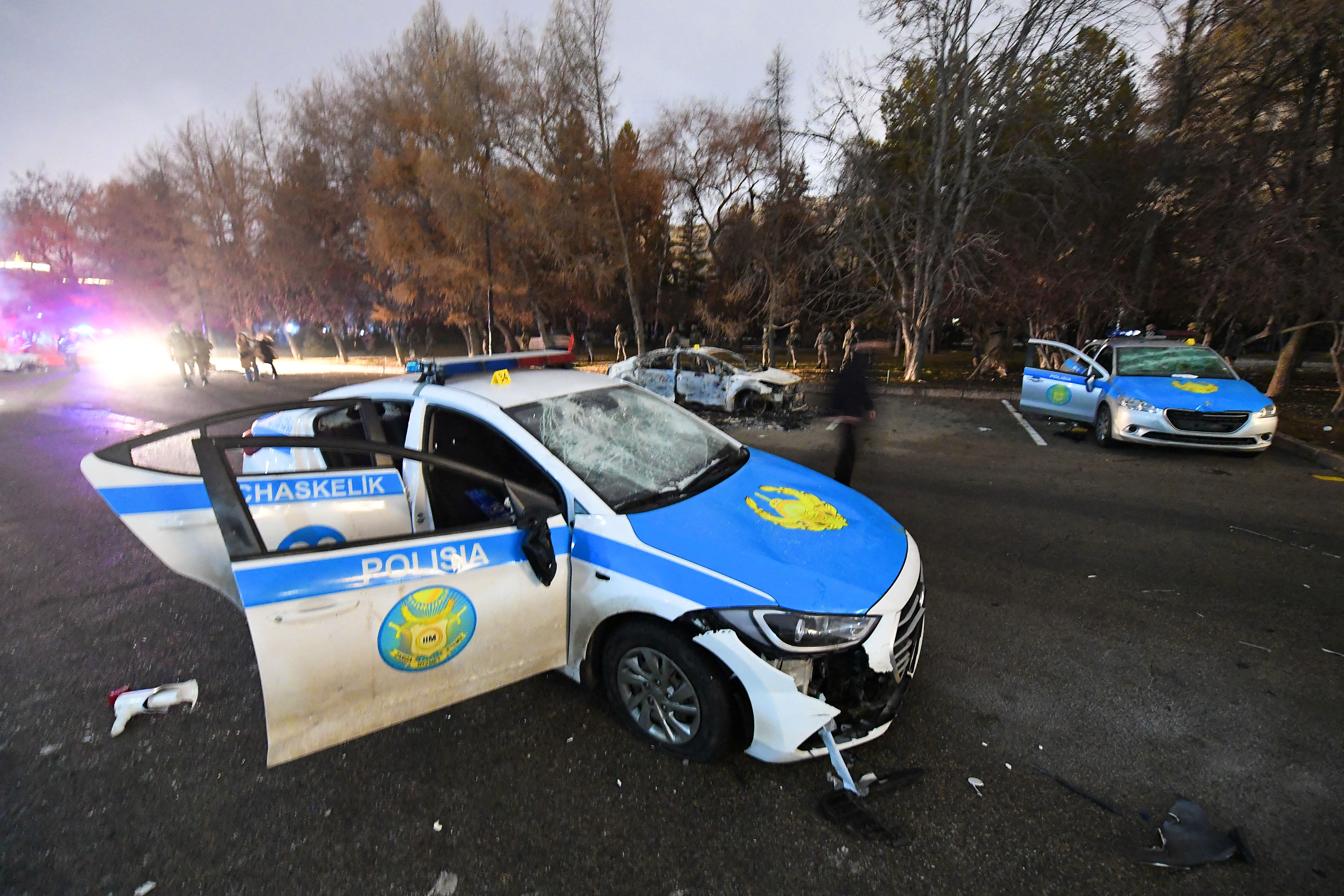 A damaged police car is seen near the mayor's office in Almaty