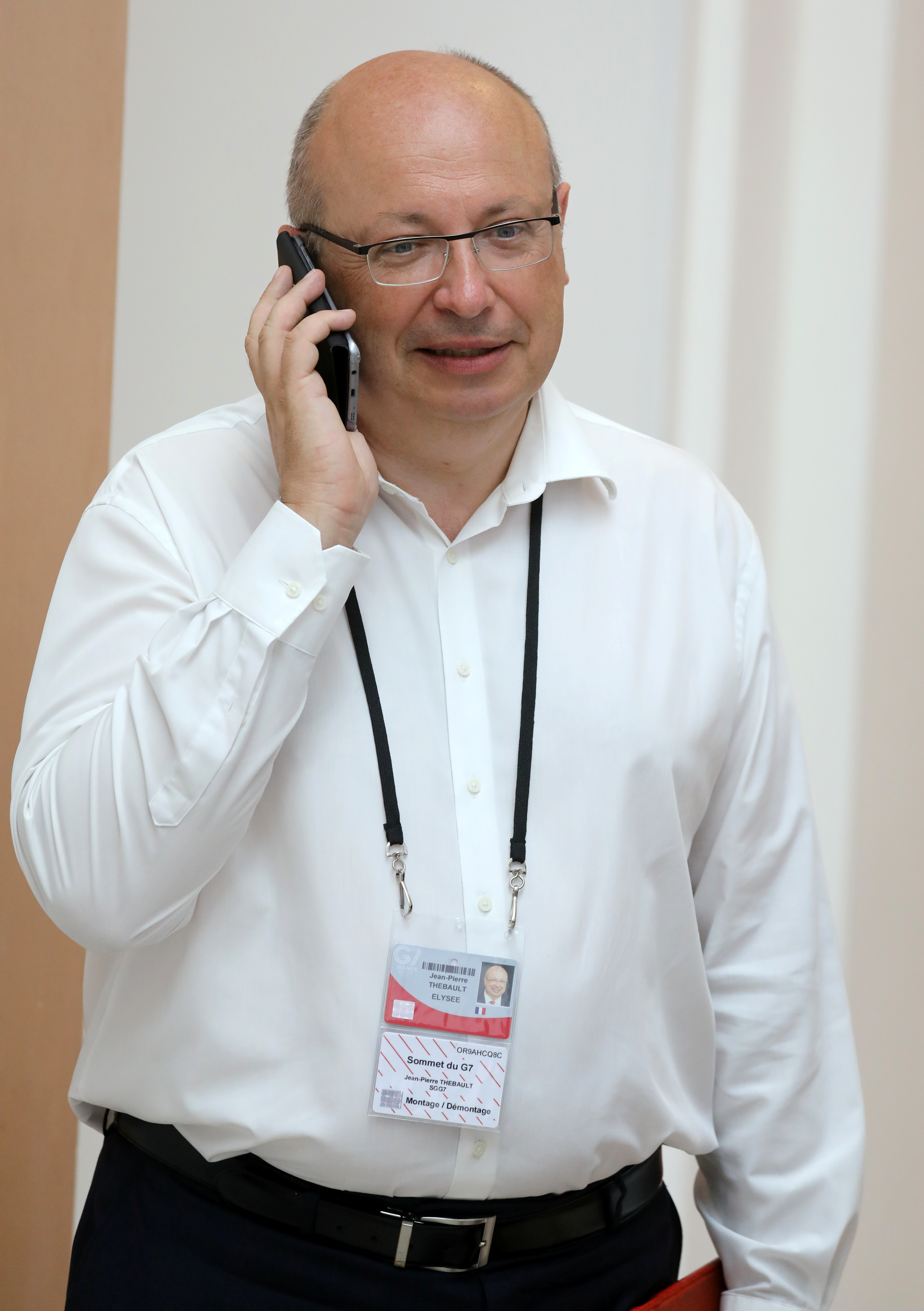 French Ambassador in charge of the G7 summit preparations Jean-Pierre Thebault speaks on his mobile phone while working in Biarritz