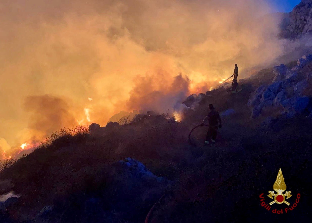 Firefighters battle wildfires in the beach village of Porto Badisco near Otranto in the southern region of Puglia, Italy, August 13, 2021. Vigili del Fuoco/Handout via REUTERS