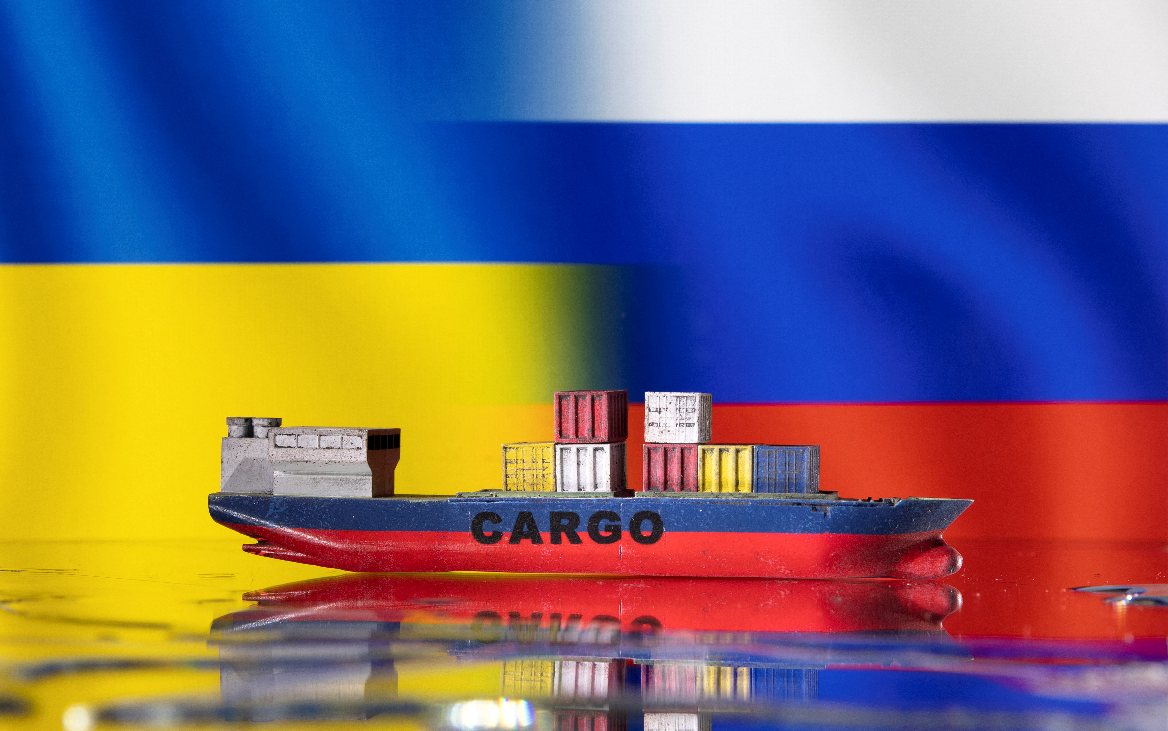 Illustration shows cargo boat model, Ukraine's and Russian's flags