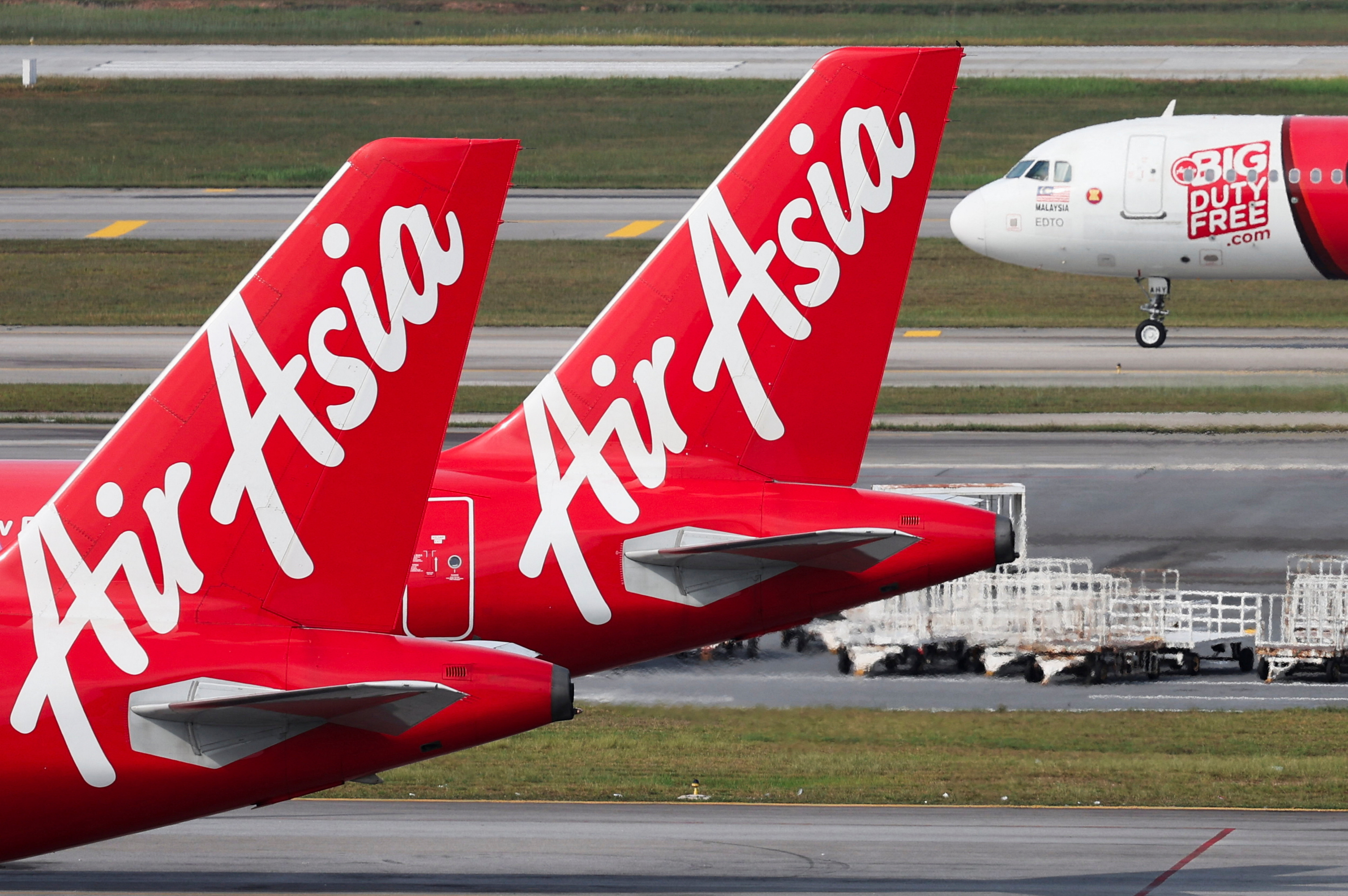 Planes from AirAsia, a subsidiary airline of Capital A, are seen on the tarmac of Kuala Lumpur International Airport Terminal 2 (KLIA2) in Sepang