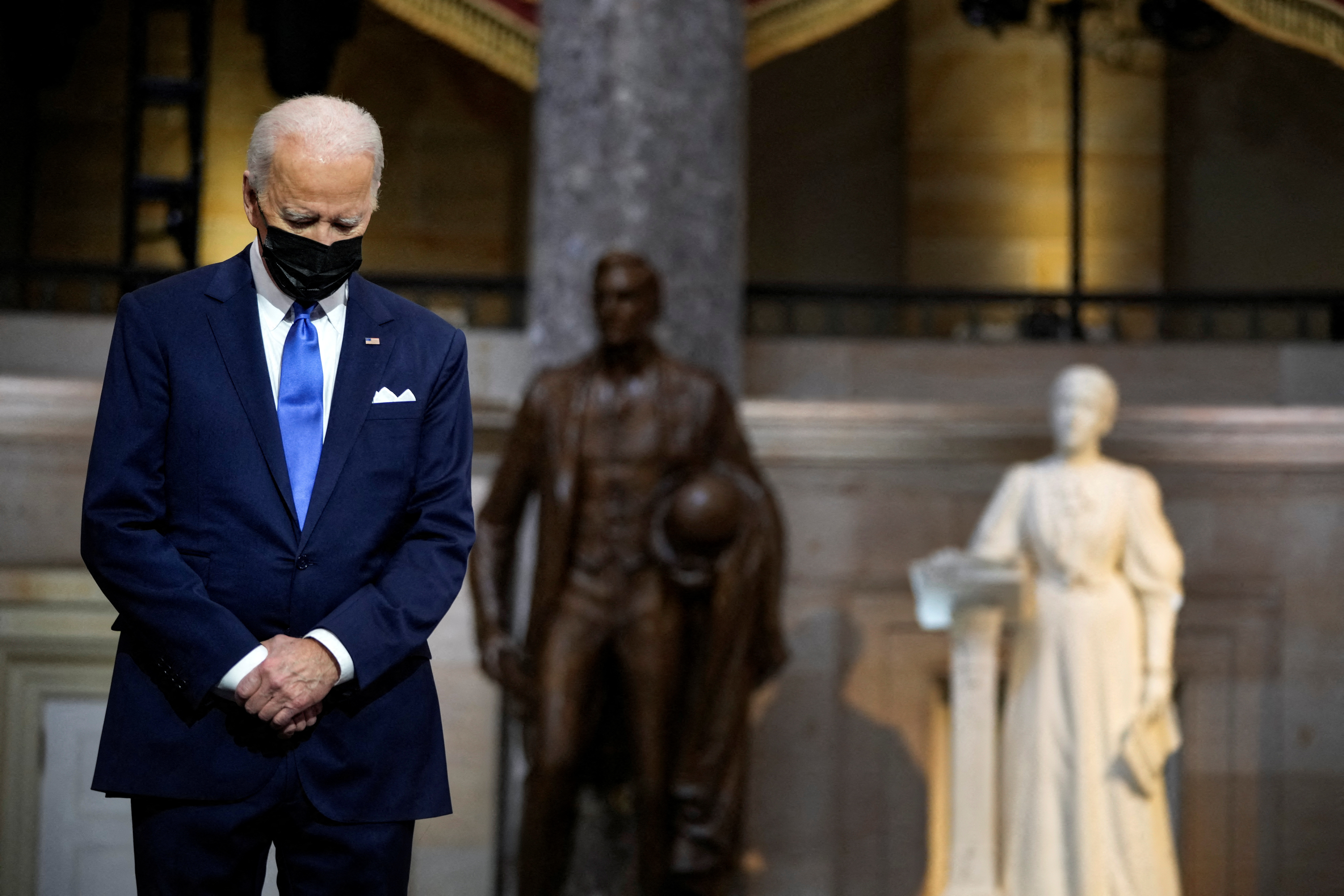 U.S. President Joe Biden listens as Vice President Kamala Harris delivers remarks in the Statuary Hall of the U.S. Capitol during a ceremony on the first anniversary of the January 6, 2021 attack on the U.S. Capitol by supporters of former President Donald Trump in Washington, D.C., U.S., January 6, 2022. Drew Angerer/Pool via REUTERS