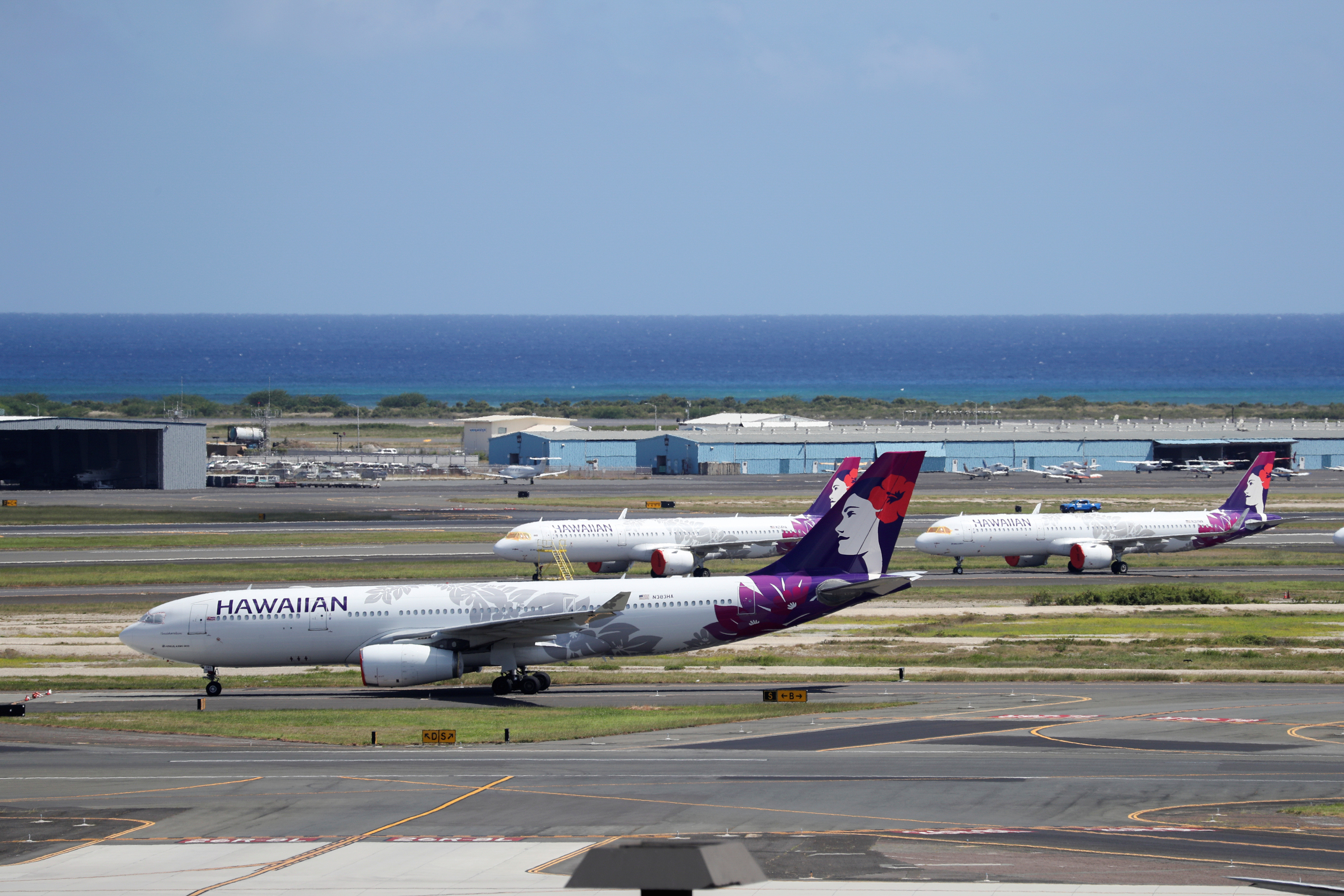 Hawaiian Airlines airplanes sit idle on the runway at the Daniel K. Inouye International Airport due to the business downturn caused by the coronavirus disease (COVID-19) in Honolulu