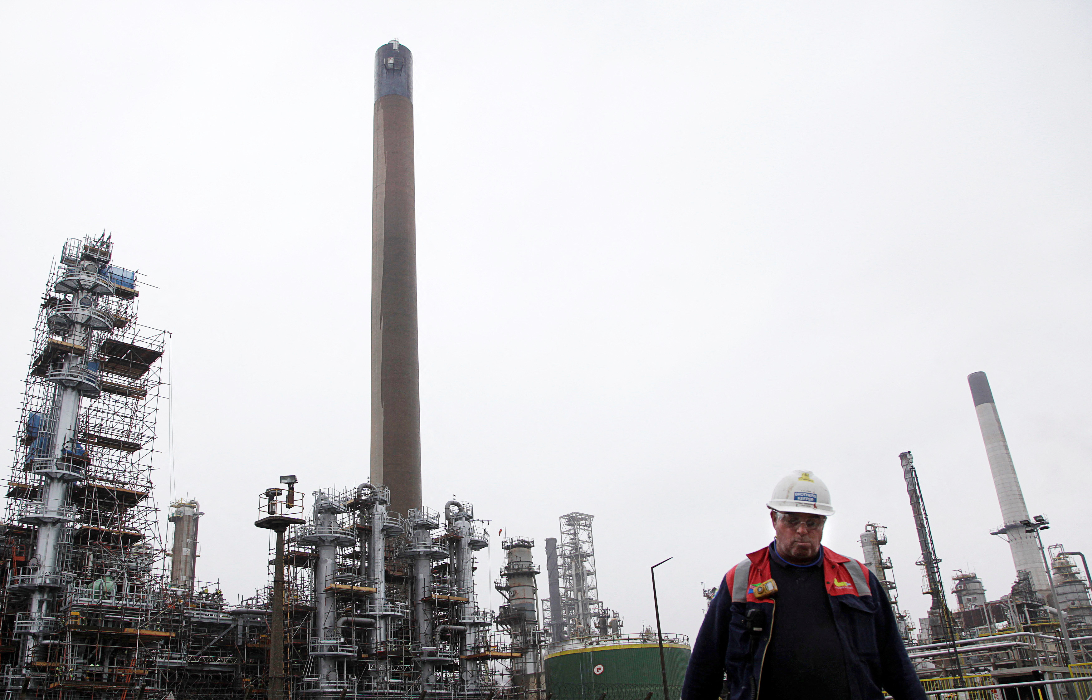 A worker walks at the Coryton oil refinery in south-eastern England