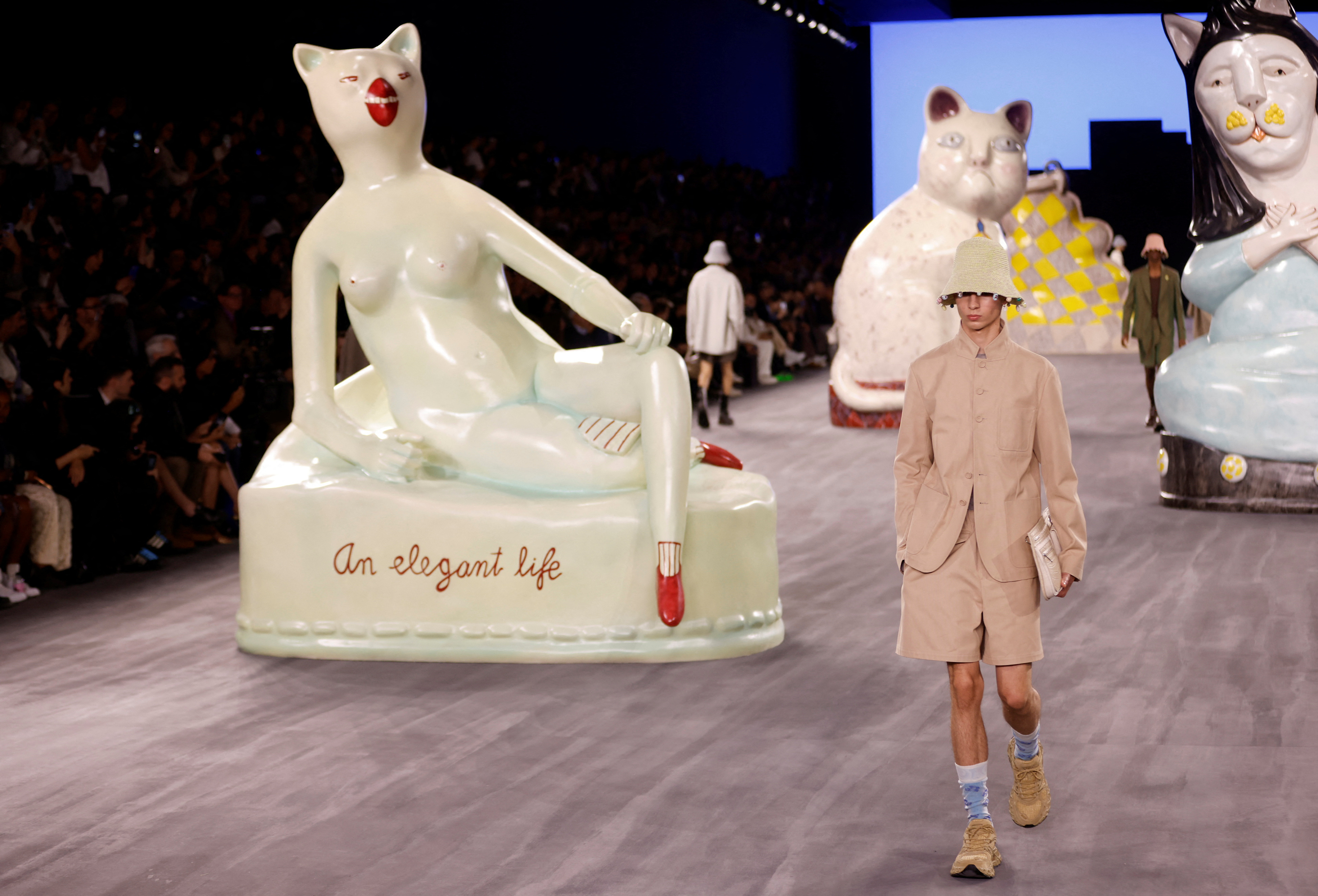 Giant cats stalk the catwalk at the Dior men's show | Reuters