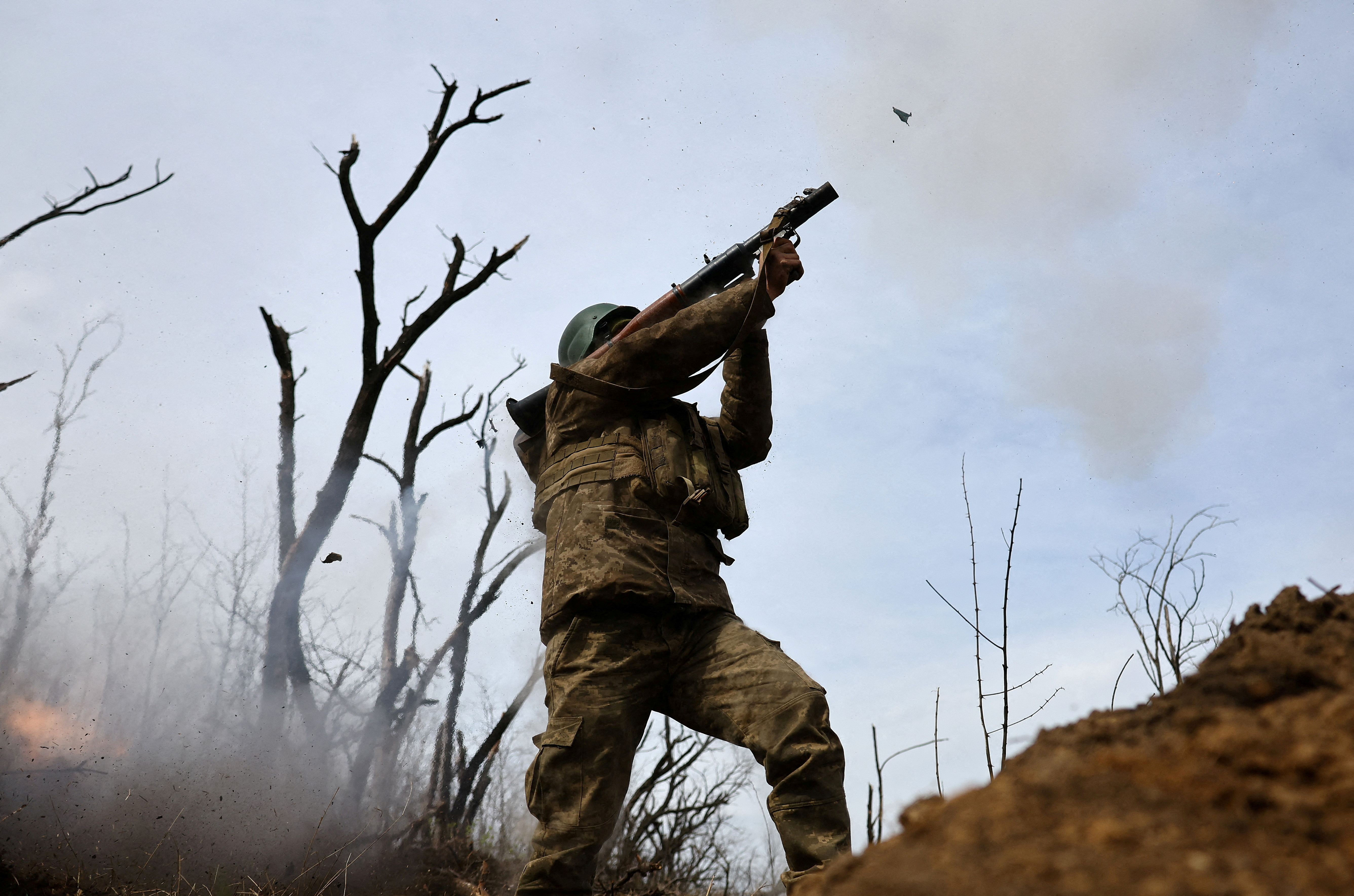 Ukrainian service members operate in the trenches at the frontline in Bakhmut region