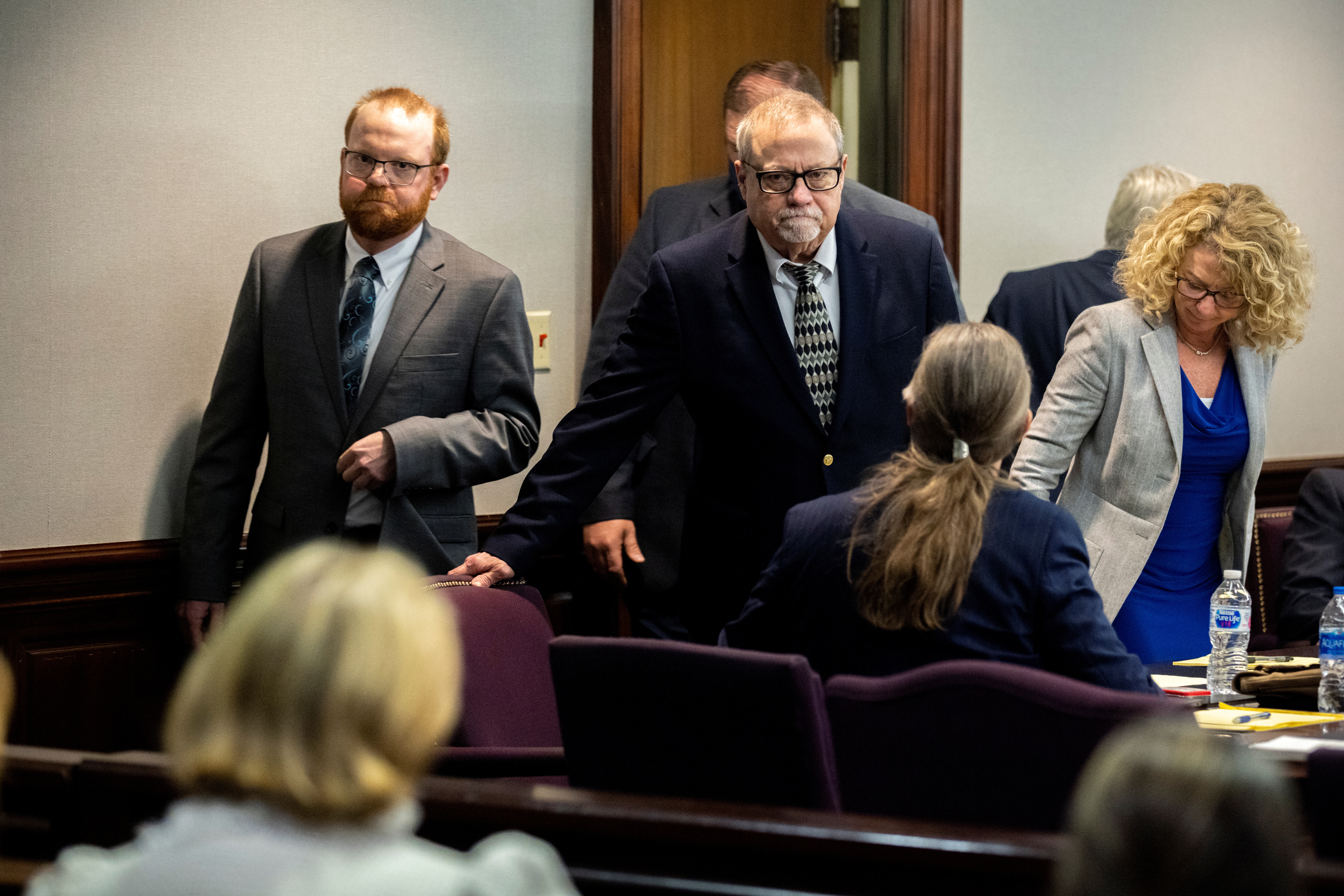 Greg McMichael and his son, Travis McMichael, look at family members seated in the gallery when they walk into the courtroom for the reading of the jury's verdict in the Glynn County Courthouse, in Brunswick, Georgia, U.S., November 24, 2021. Stephen B. Morton/Pool via REUTERS