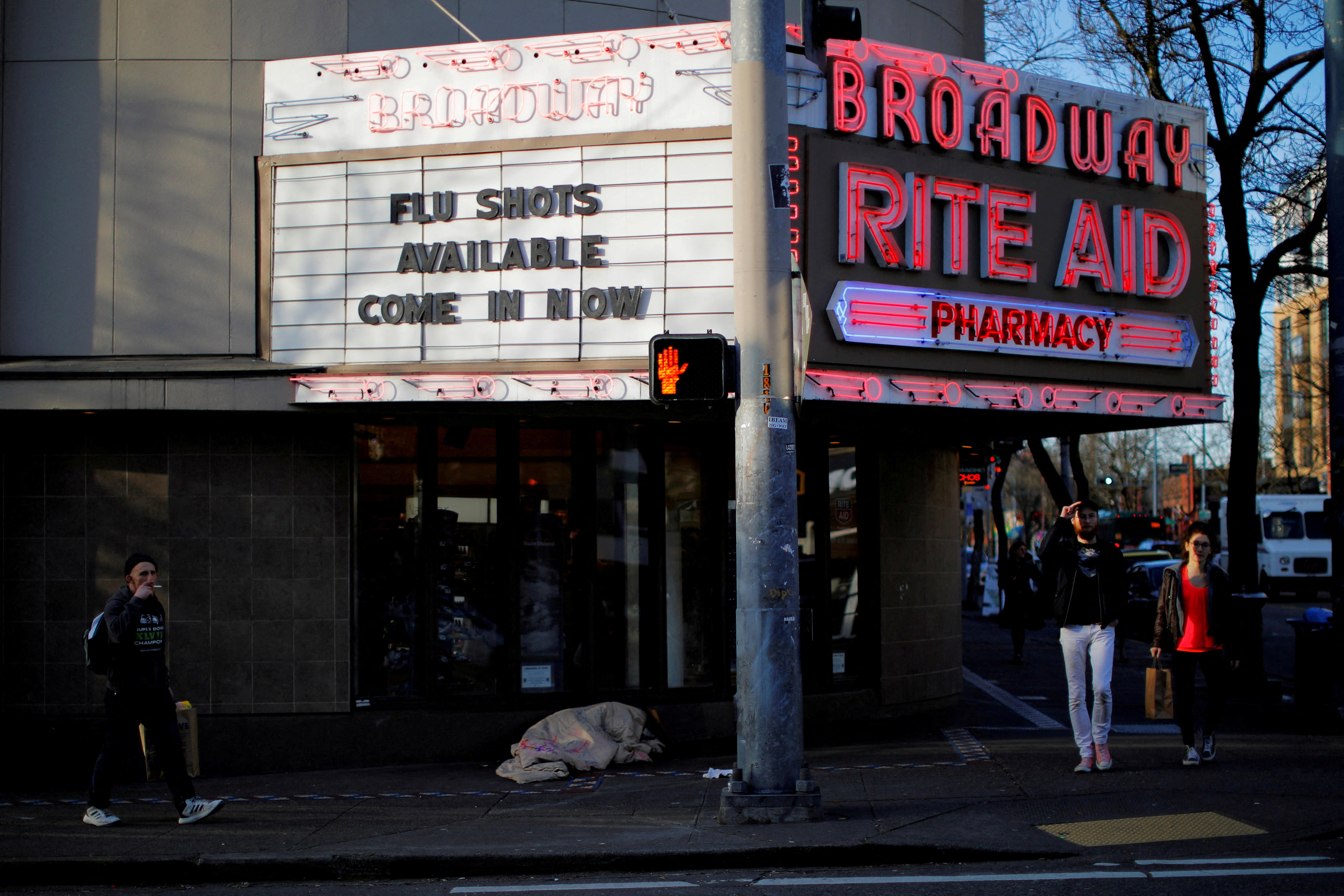 The sign over a drug store advertises flu shots amid the coronavirus outbreak in Seattle