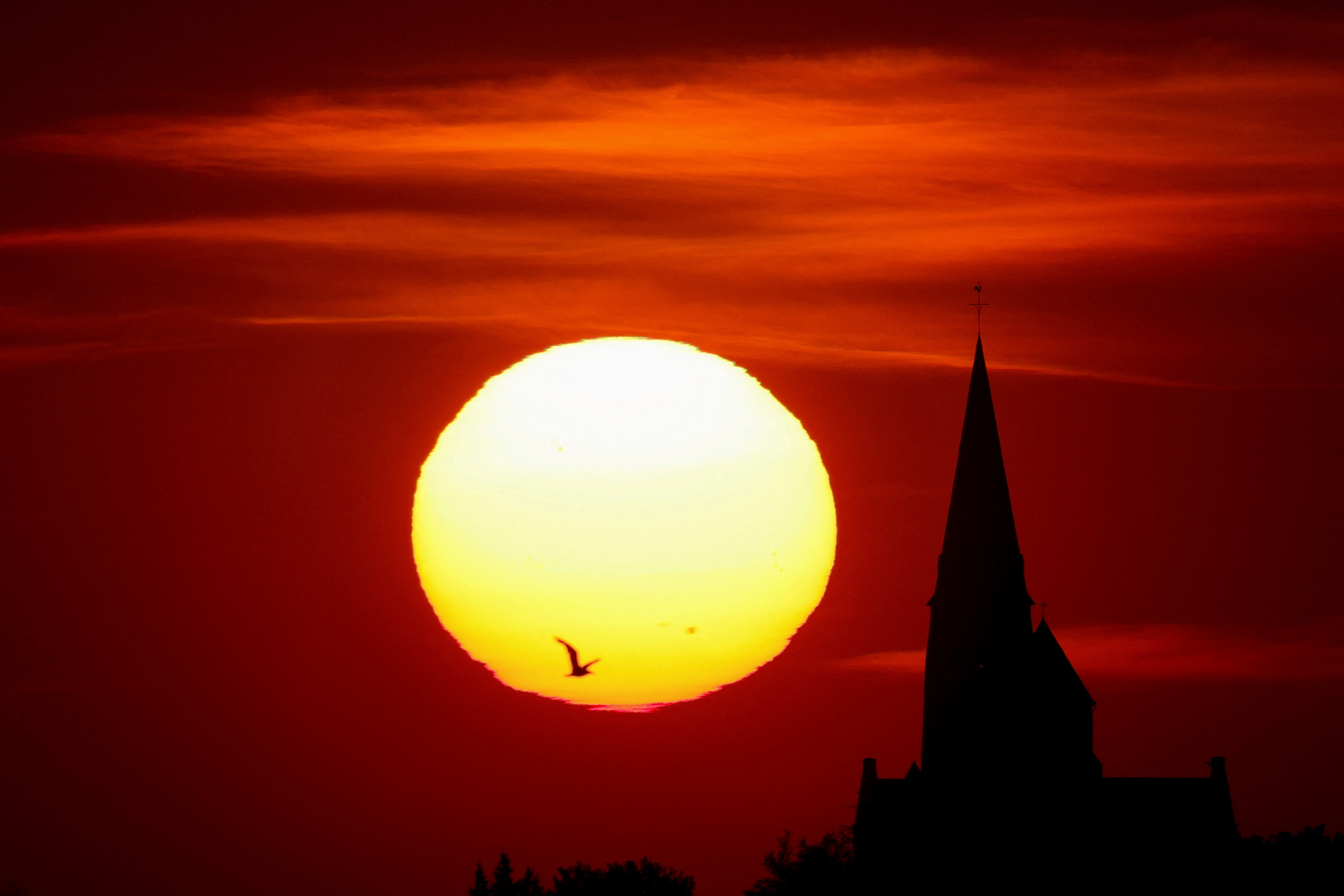 A church is pictured during sunset as a heat wave hits Europe