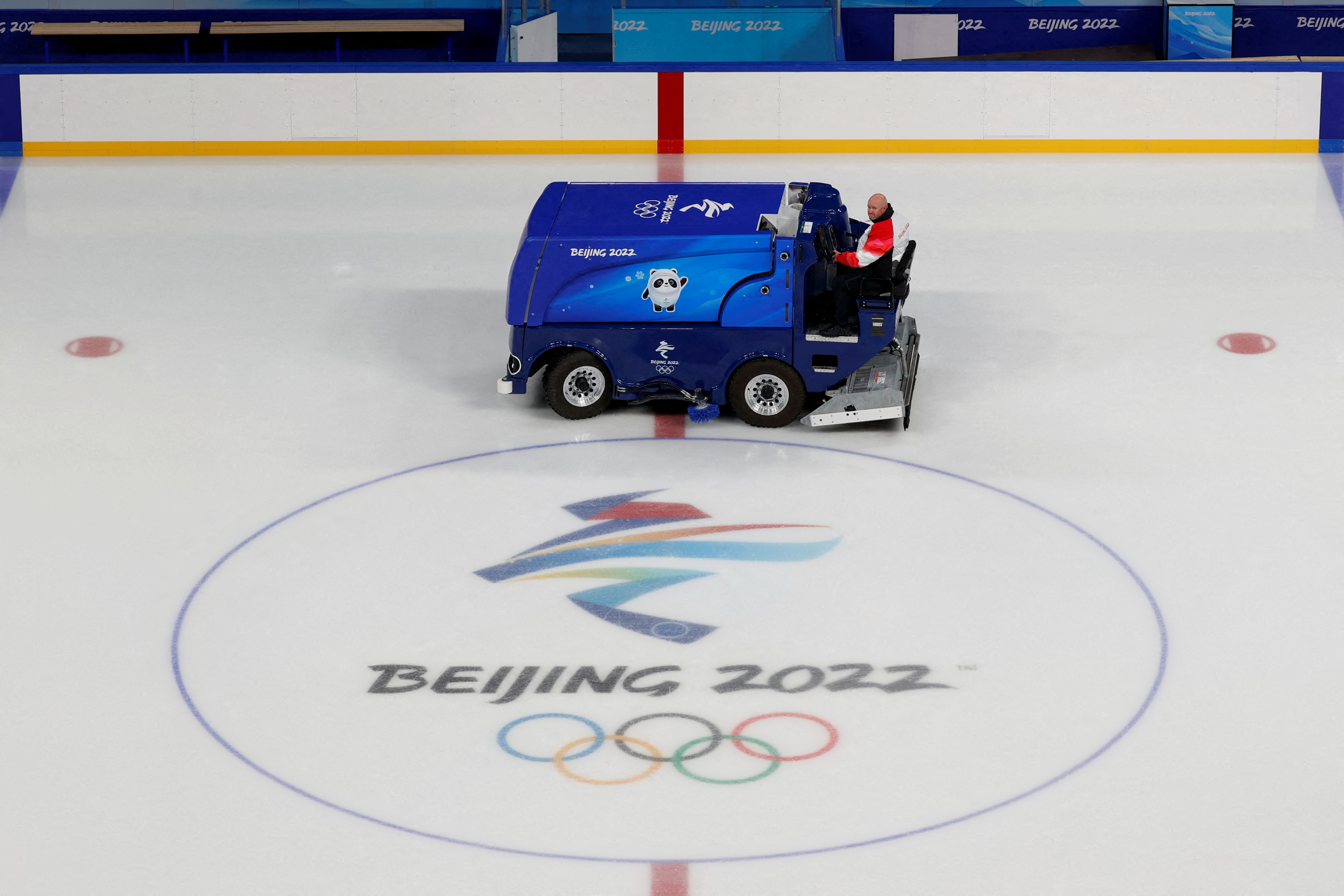 Rick Ragan, chief icemaker for the main hockey venue at the 2022 Winter Olympics, the Wukesong Arena, poses with ice resurfacer, in Beijing