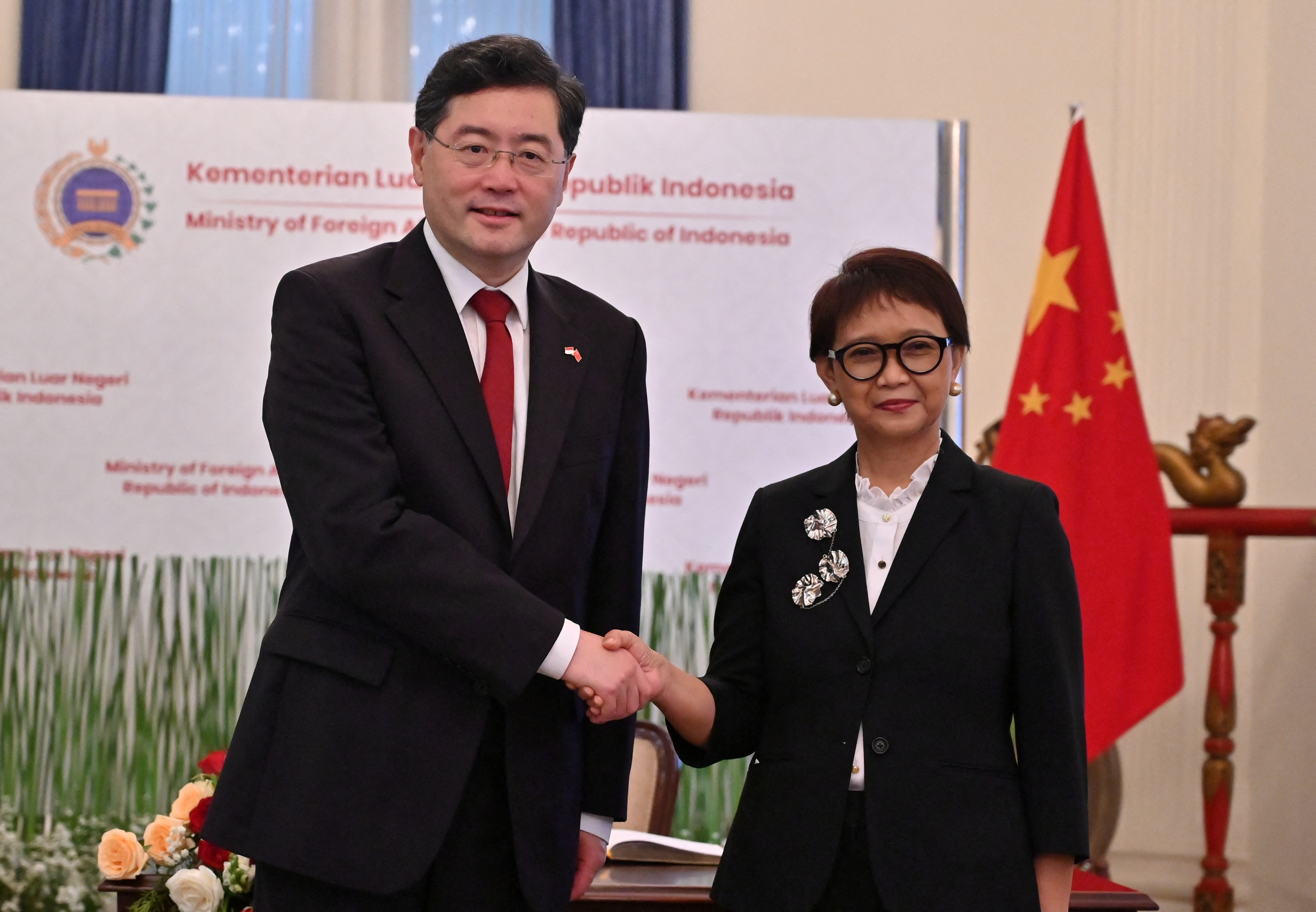 Chinese Foreign Minister Qin Gang shake hands with Indonesian Foreign Minister Retno Marsudi during the photo session in Jakarta