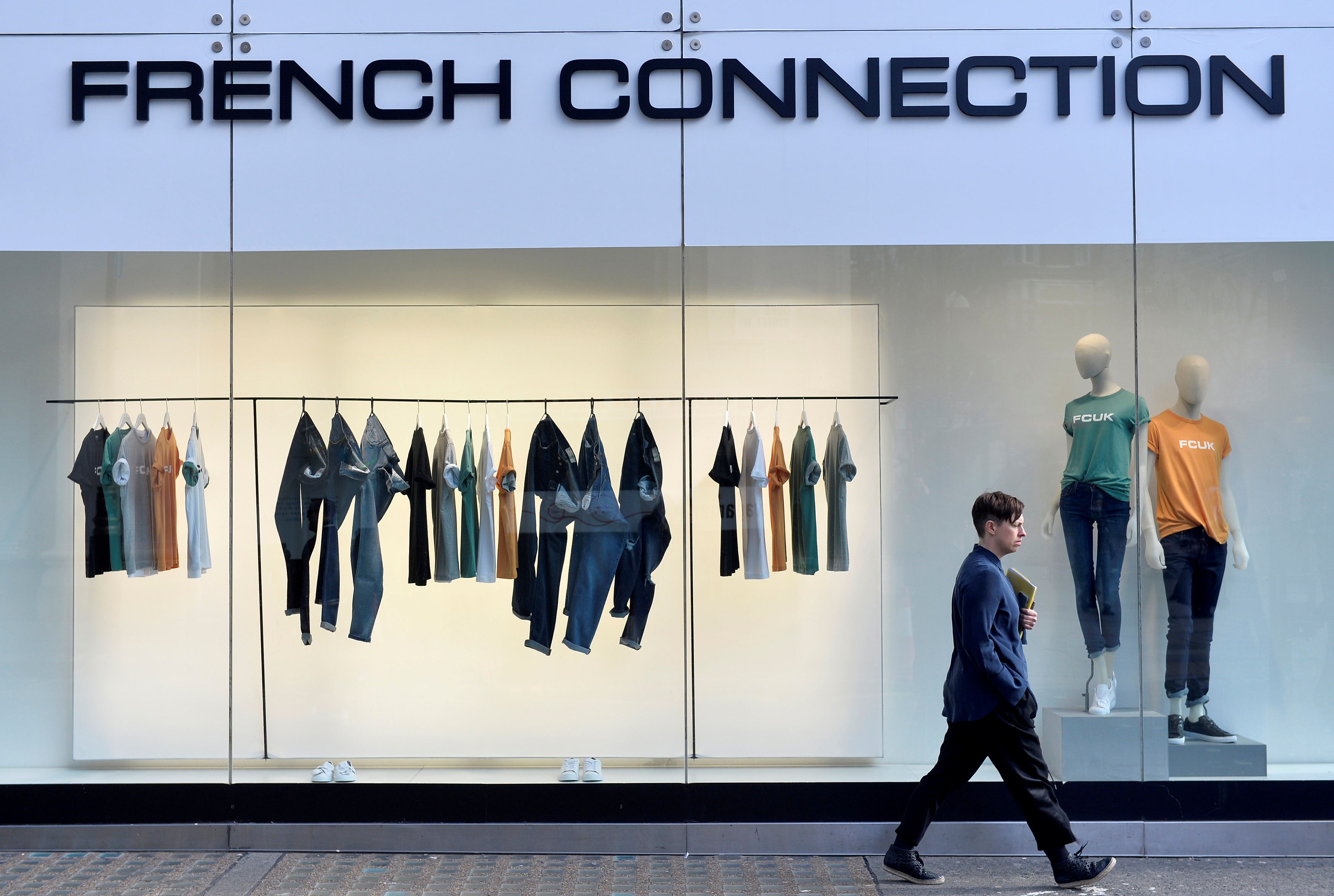 A person walks past a French Connection store in London, Britain