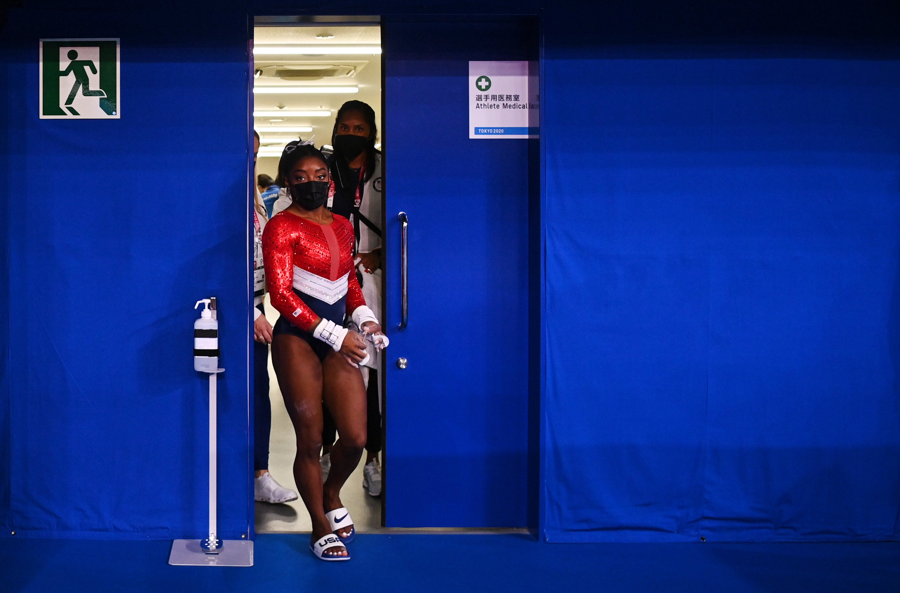 Tokyo 2020 Olympics - Gymnastics - Artistic - Women's Team - Final - Ariake Gymnastics Centre, Tokyo, Japan - July 27, 2021. Simone Biles of the United States wearing a protective face mask is seen leaving a medical station during the final REUTERS/Dylan Martinez