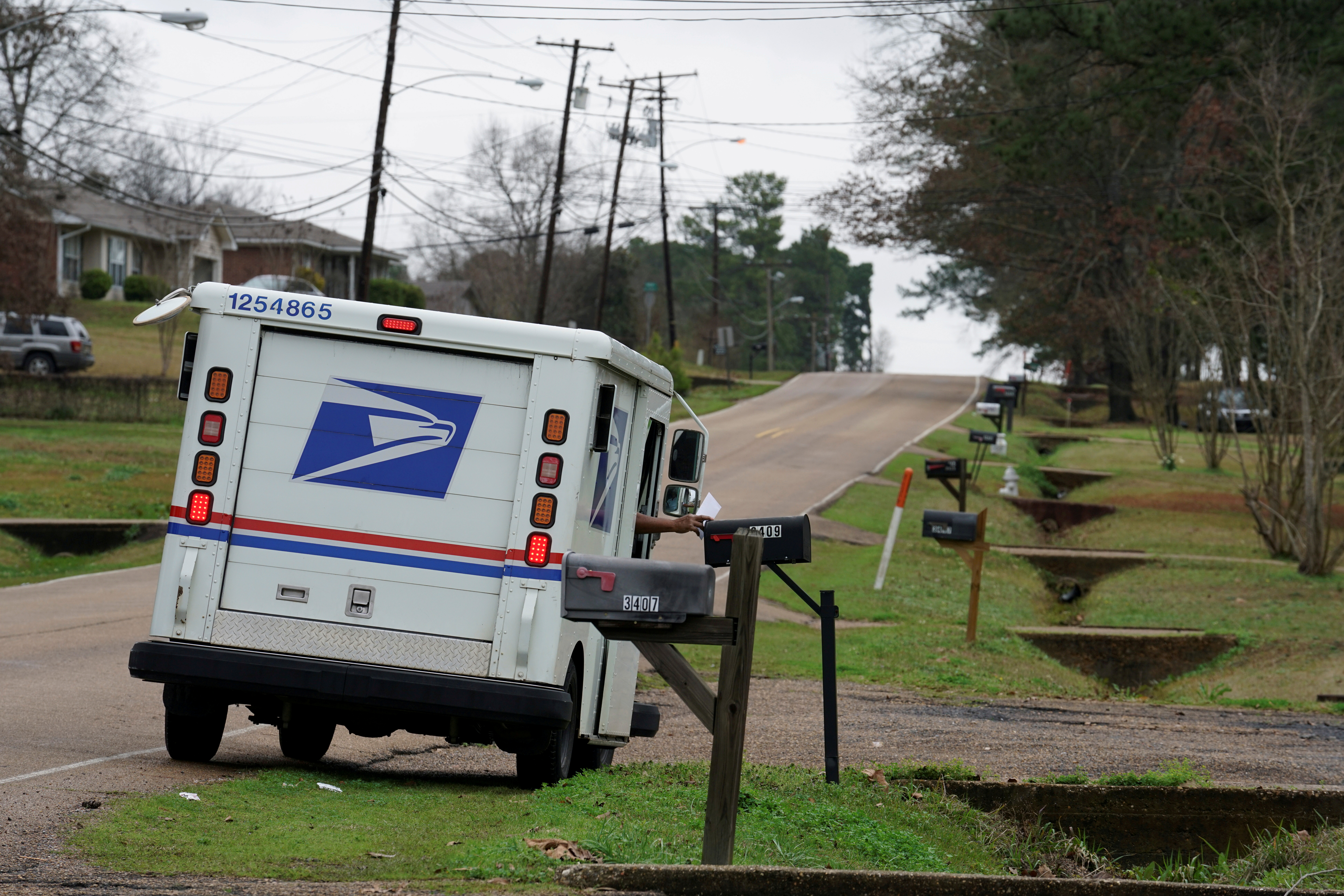 A mail carrier delivers the mail in Pearl, Mississippi, U.S. January 15, 2020. REUTERS/Veronica G. Cardenas/File Photo