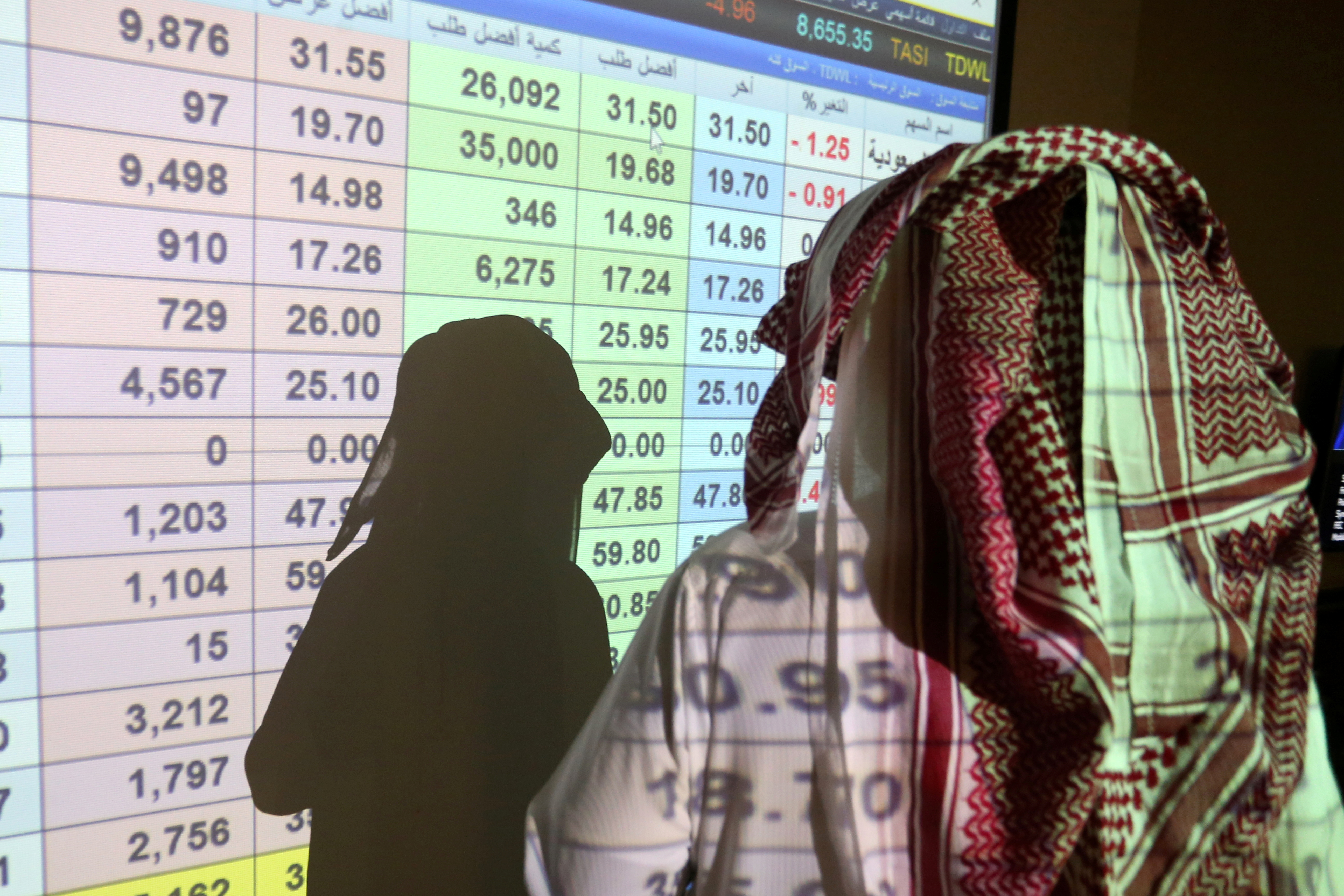 A Saudi trader monitors stock information at ANB Bank in Riyadh