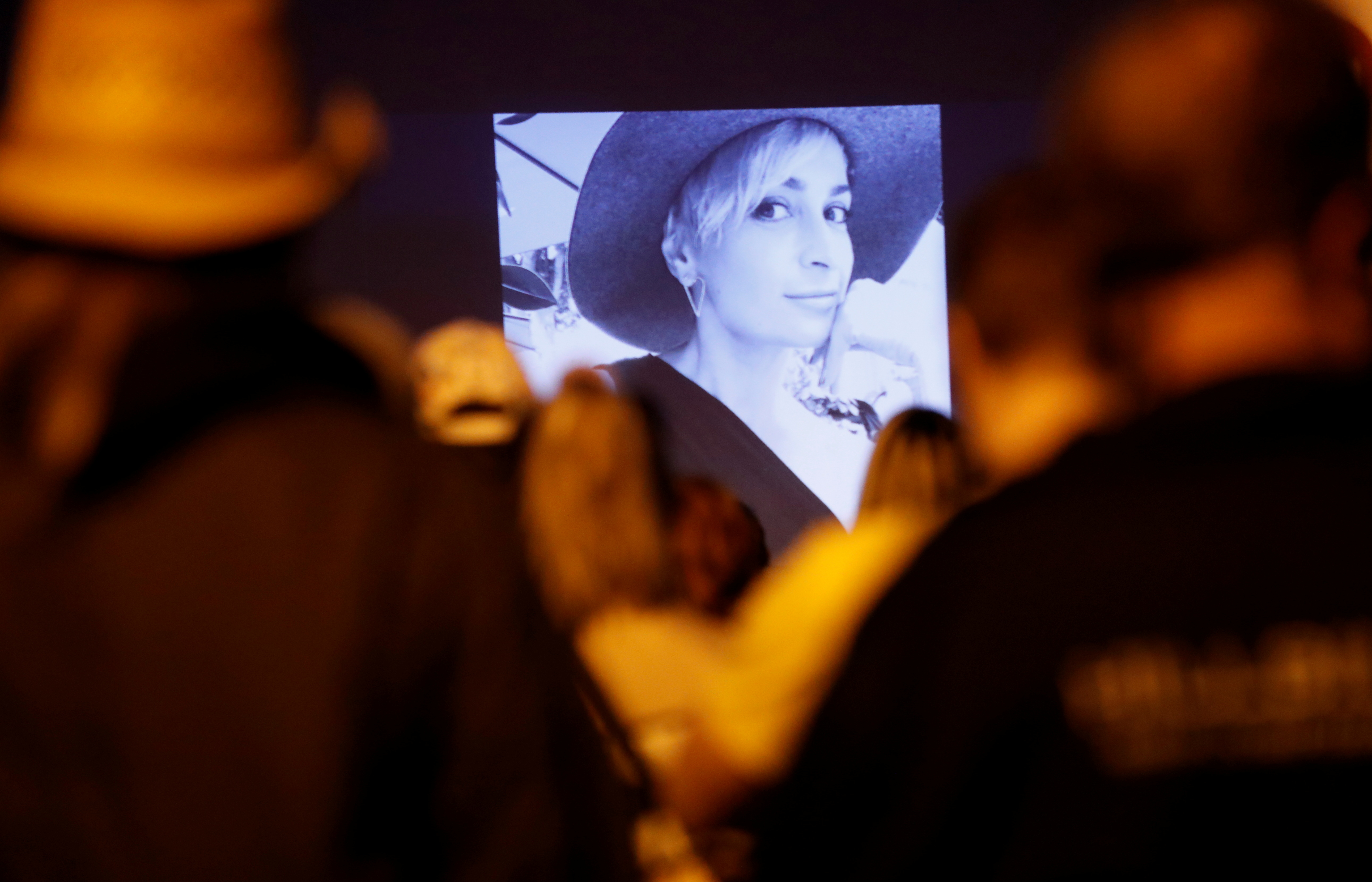 People attend a vigil for cinematographer Halyna Hutchins, who was fatally shot on the film set of 