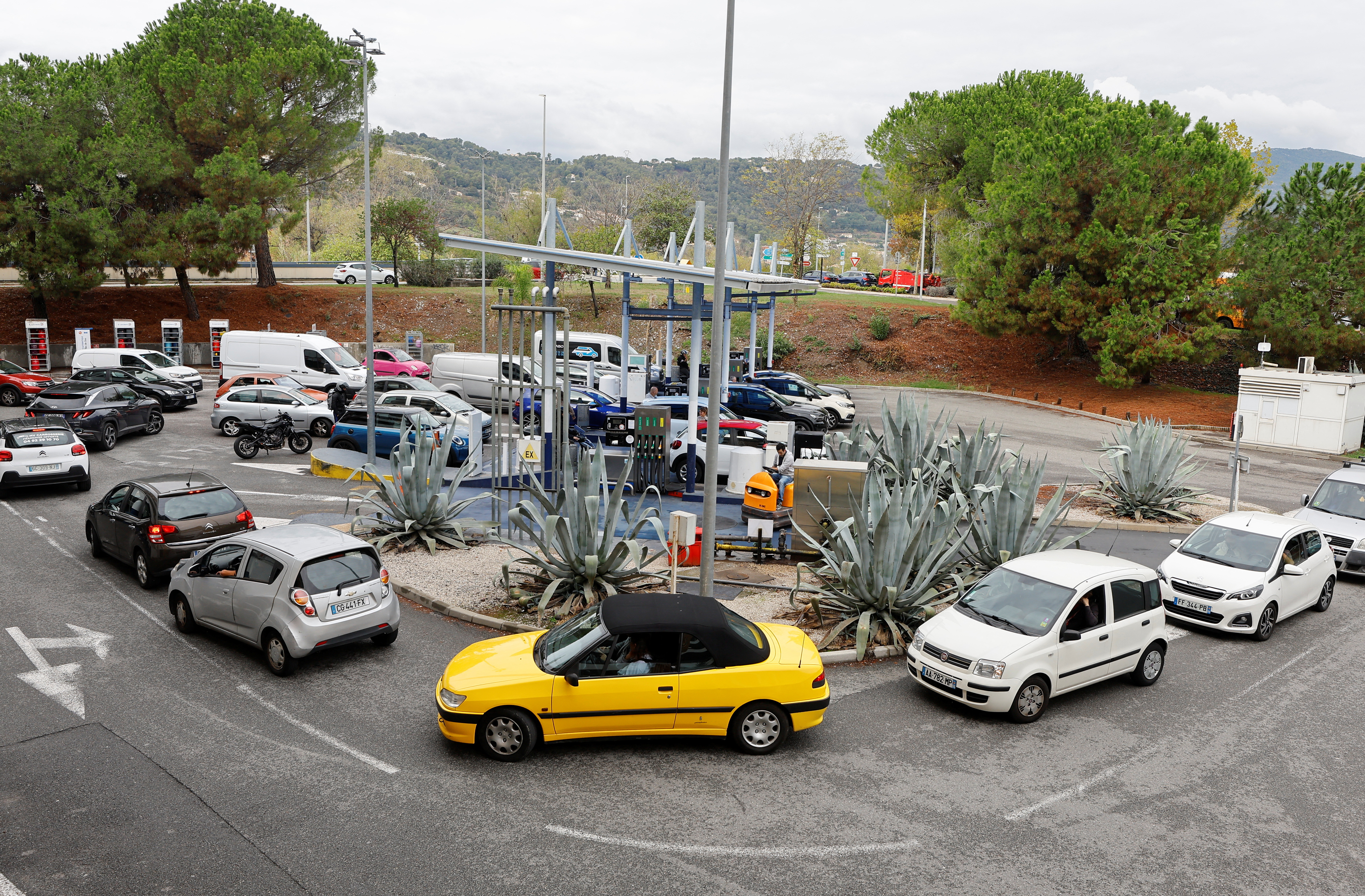 Cars queue to fill their fuel tanks at a petrol station in Nice