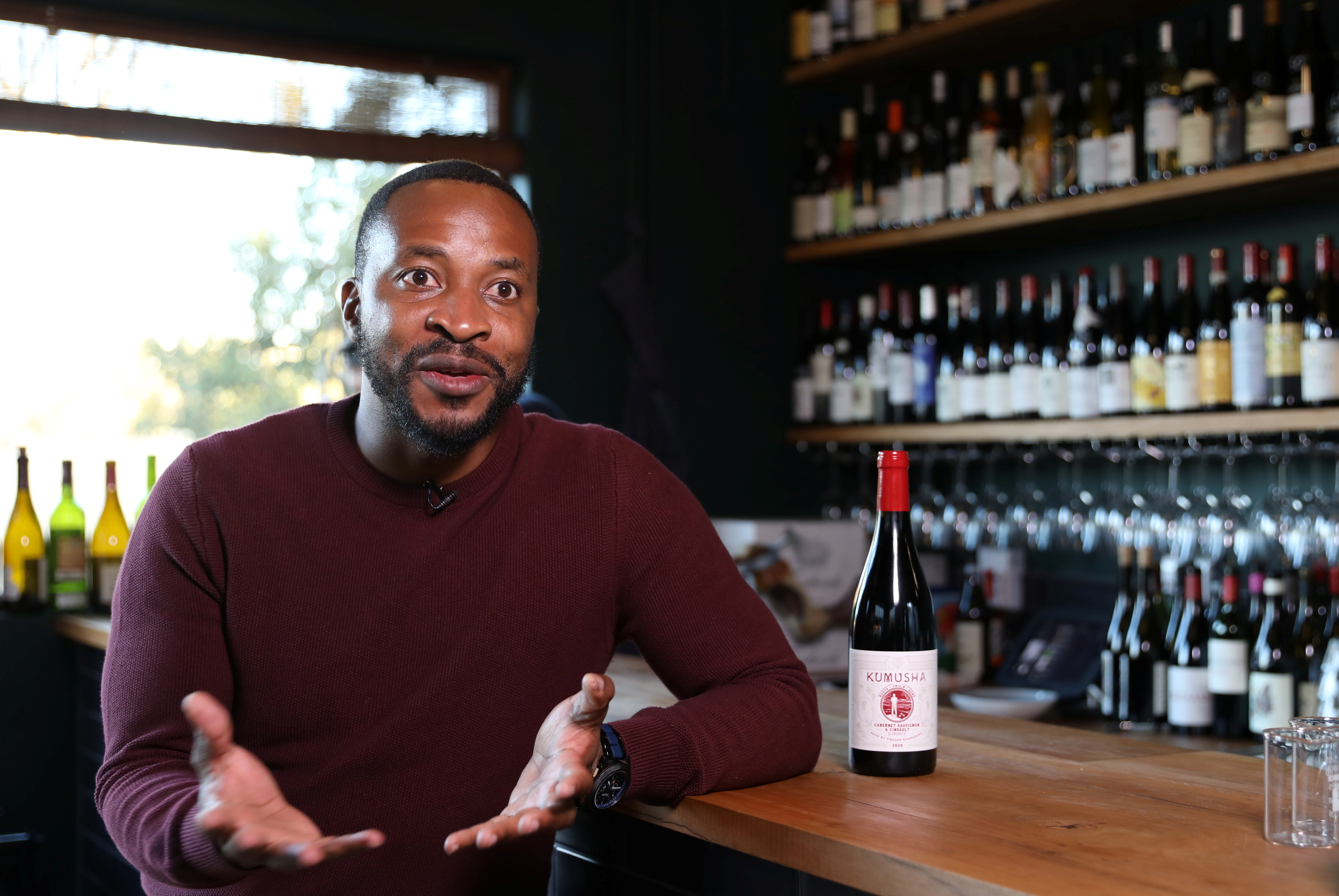Zimbabwean Tinashe Nyamudoka, a famed sommelier with his own wine brand, gestures as he speaks during an interview with Reuters in Johannesburg, South Africa, June 25, 2021. REUTERS/Siphiwe Sibeko.