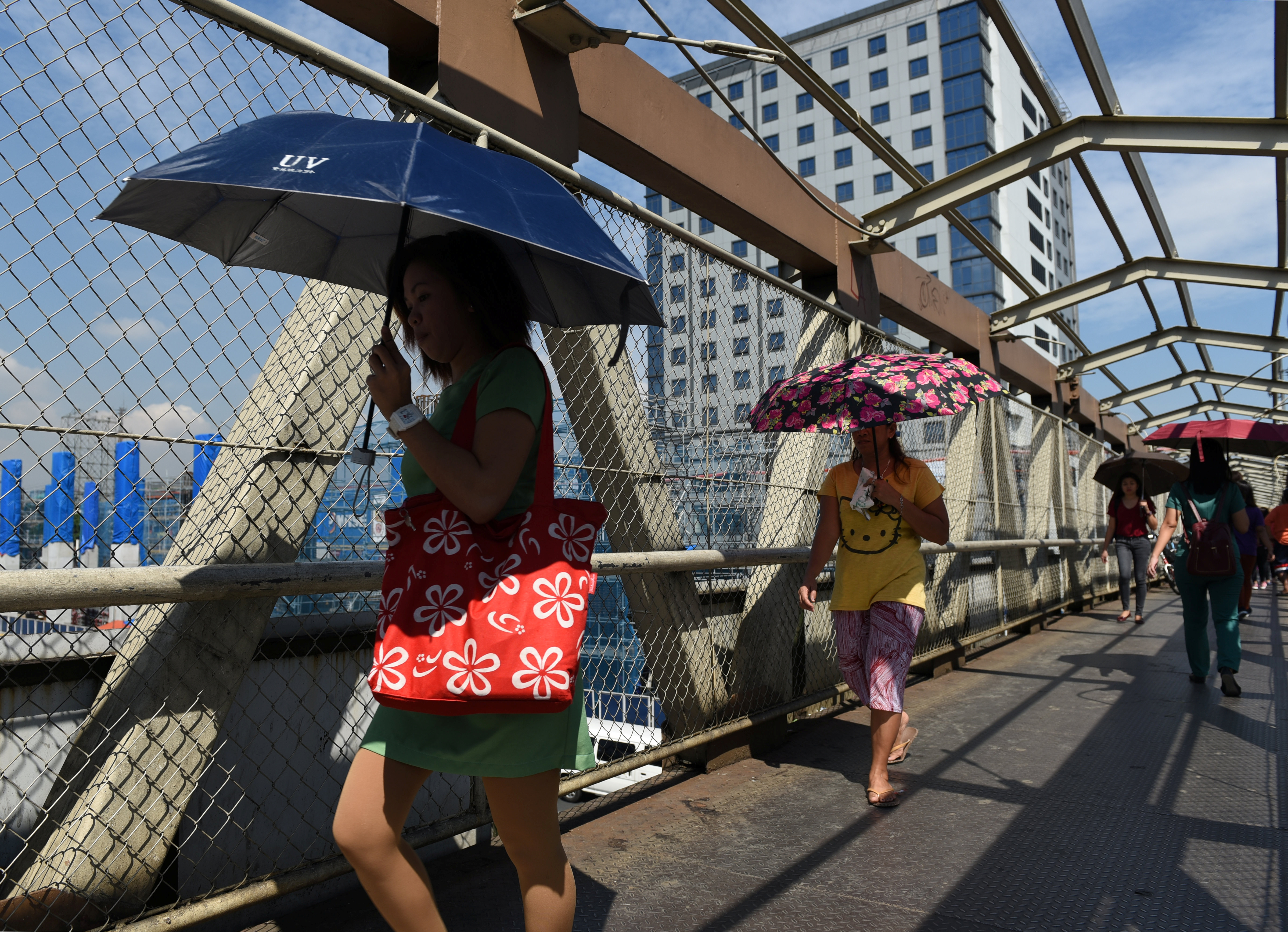 Commuters pass through an elevated pedestrian walkway on Commonwealth Avenue