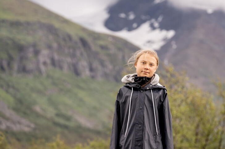 Climate activist Greta Thunberg poses for a photo by the Ahkka mountain at the world heritage site of the Laponia area in Sapmi