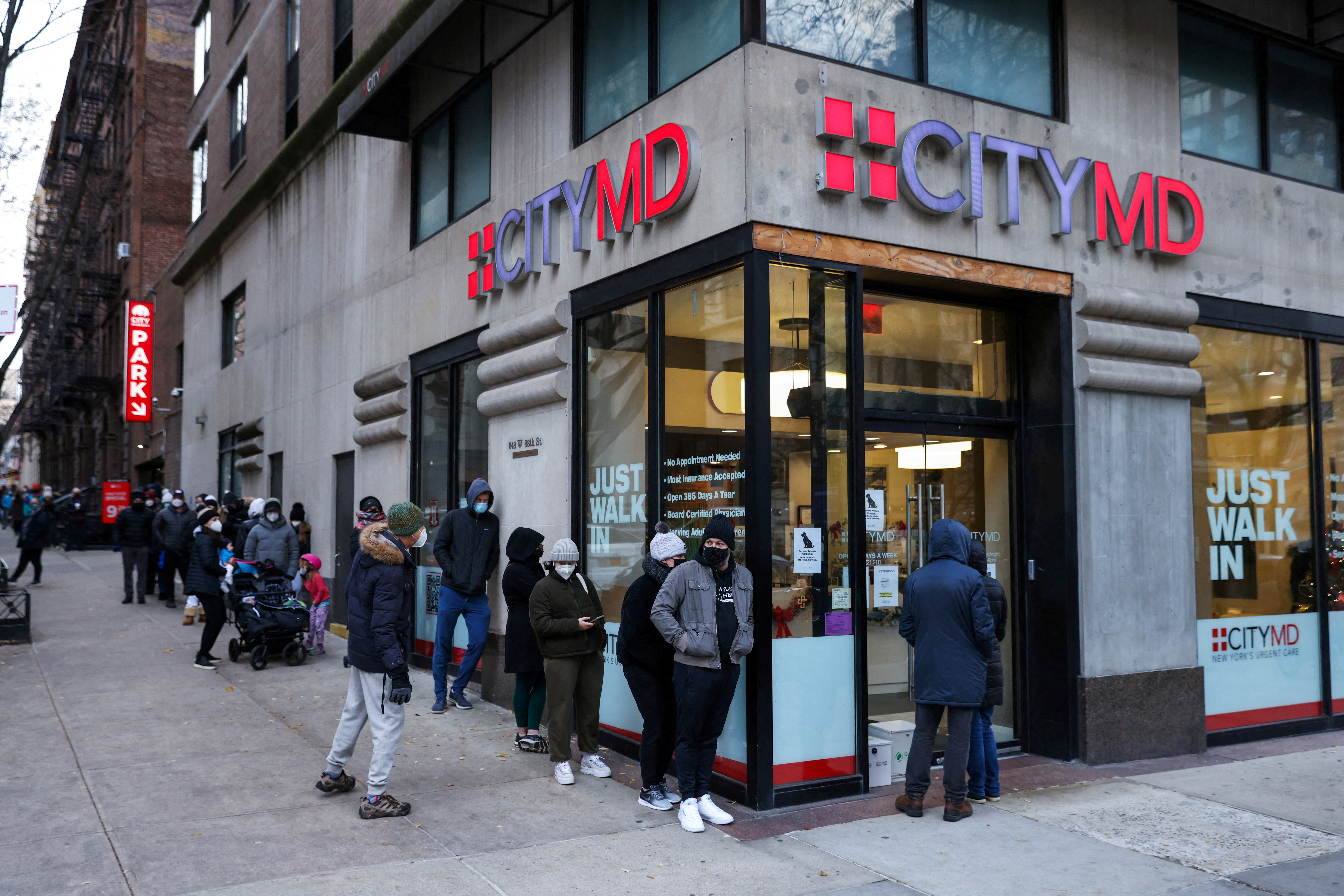 People wait in a queue to enter CityMD, a health clinic that offers coronavirus disease (COVID-19) testing, on the Upper West Side as the Omicron coronavirus variant continues to spread in Manhattan, New York City