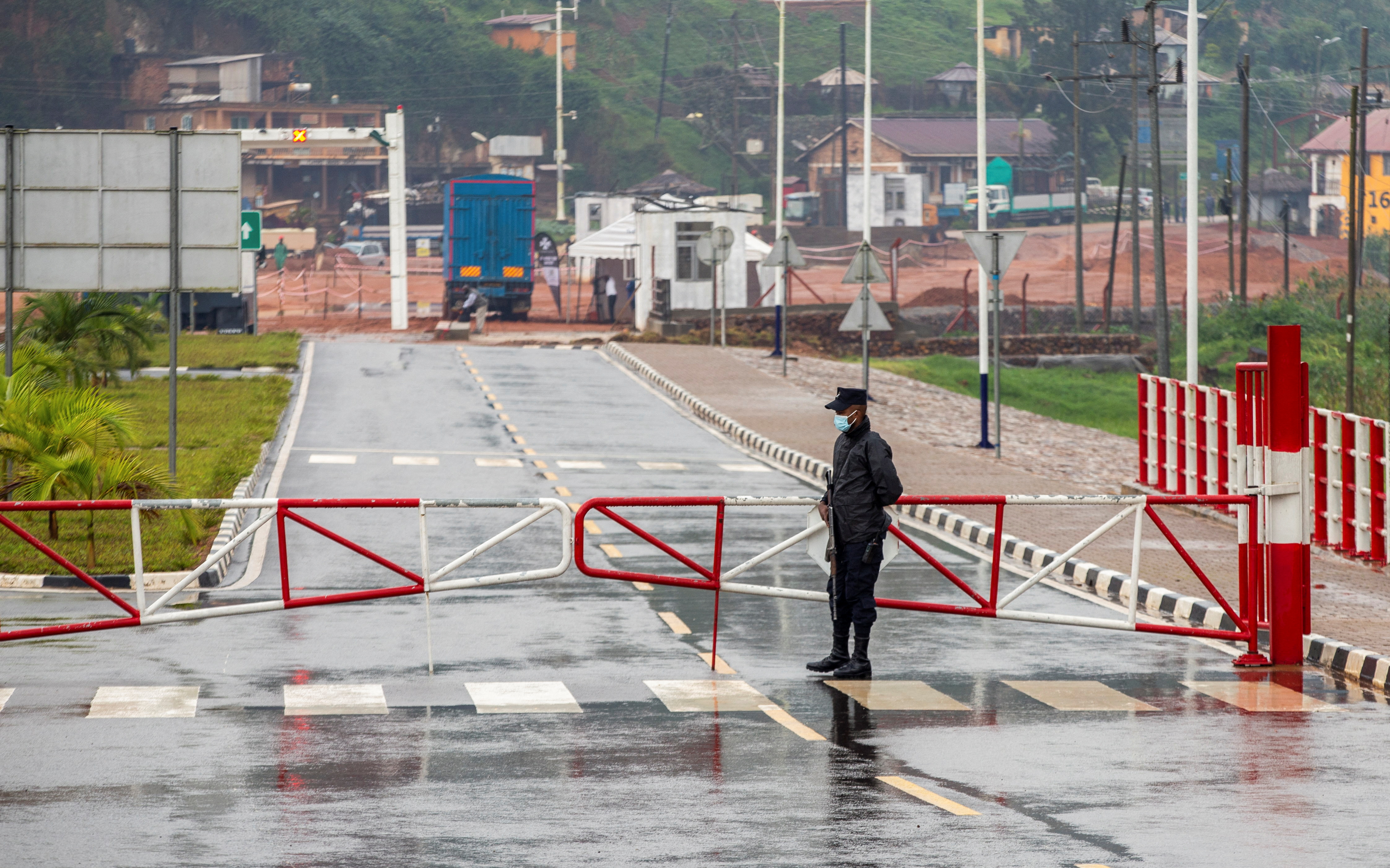 Rwandan police officer stands guard at the barrier of the Gatuna one-stop border post at Gicumbi