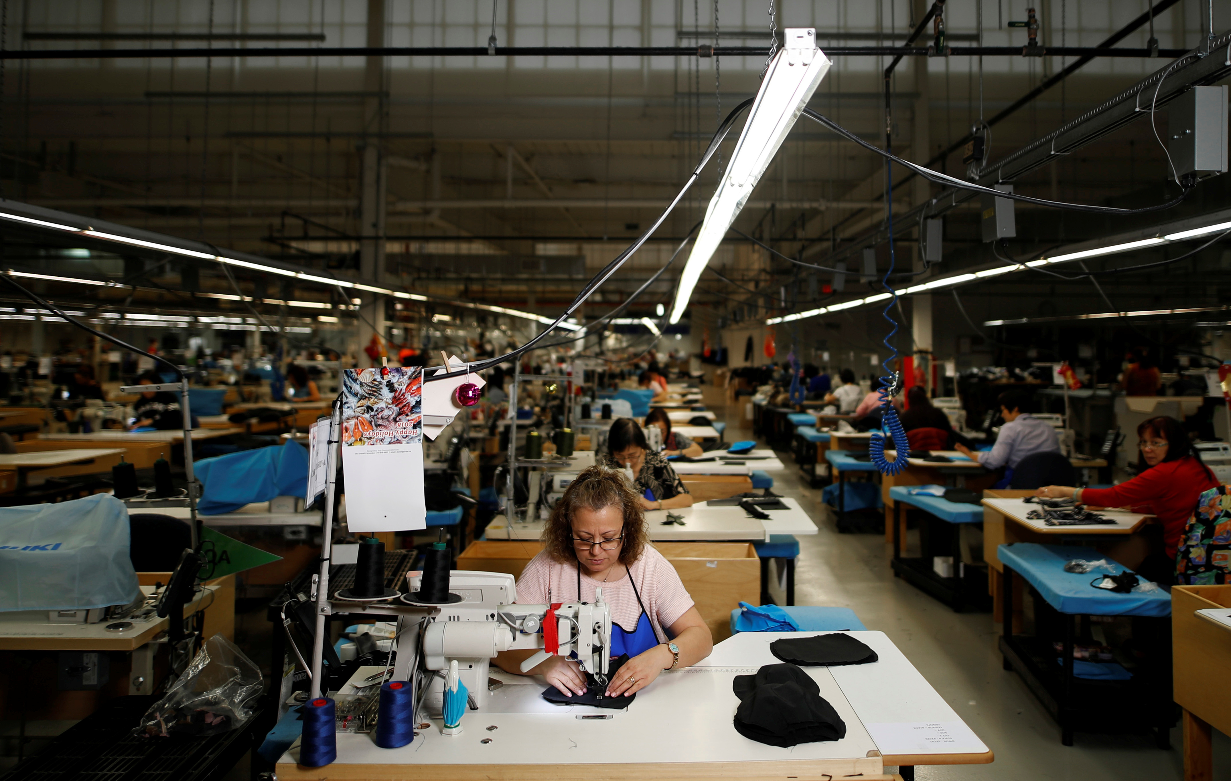 Workers make jackets at the Canada Goose factory in Toronto