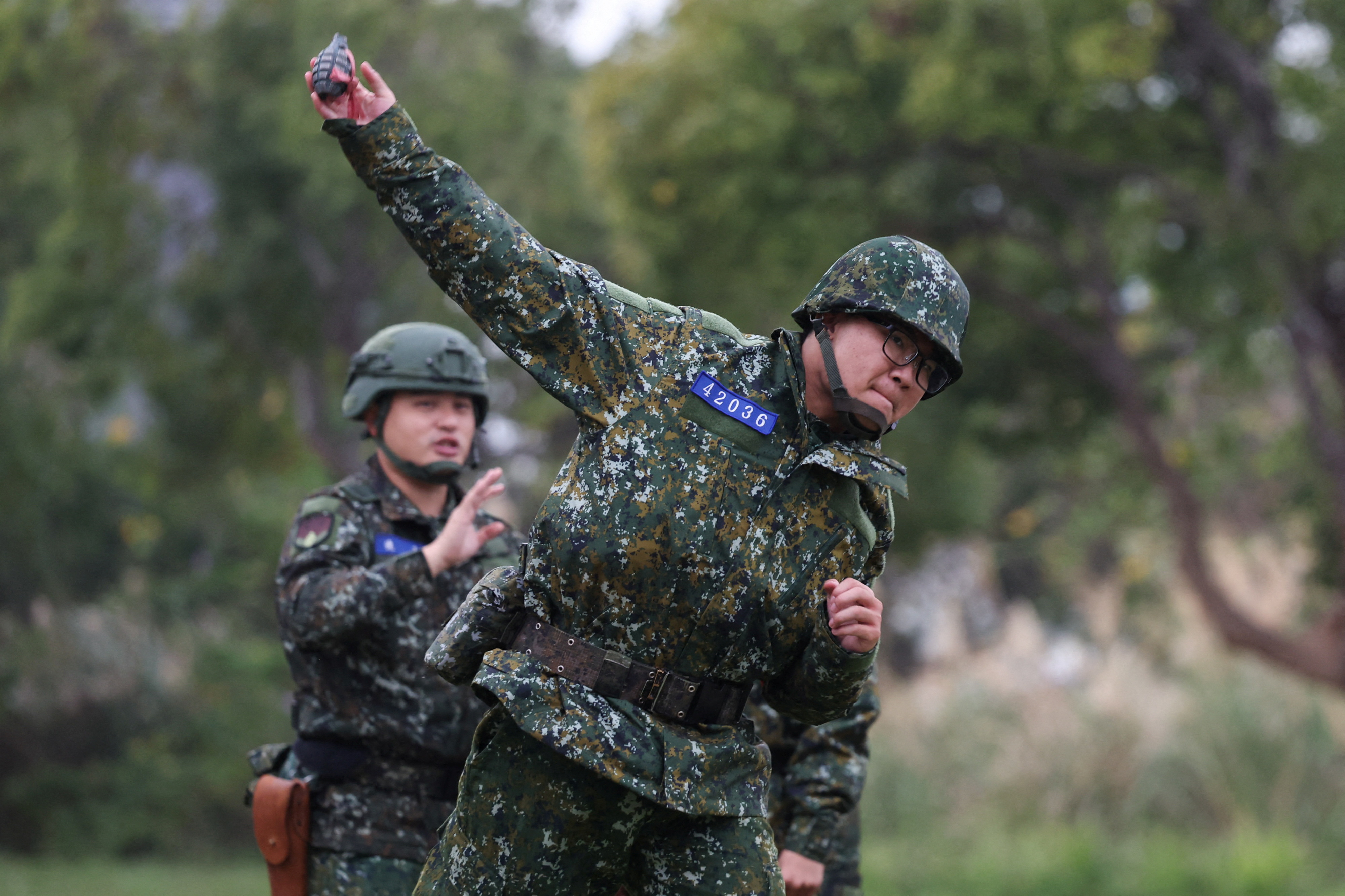 A soldier trains to throw grenade ahead of the Lunar New Year at an army base in Hsinchu