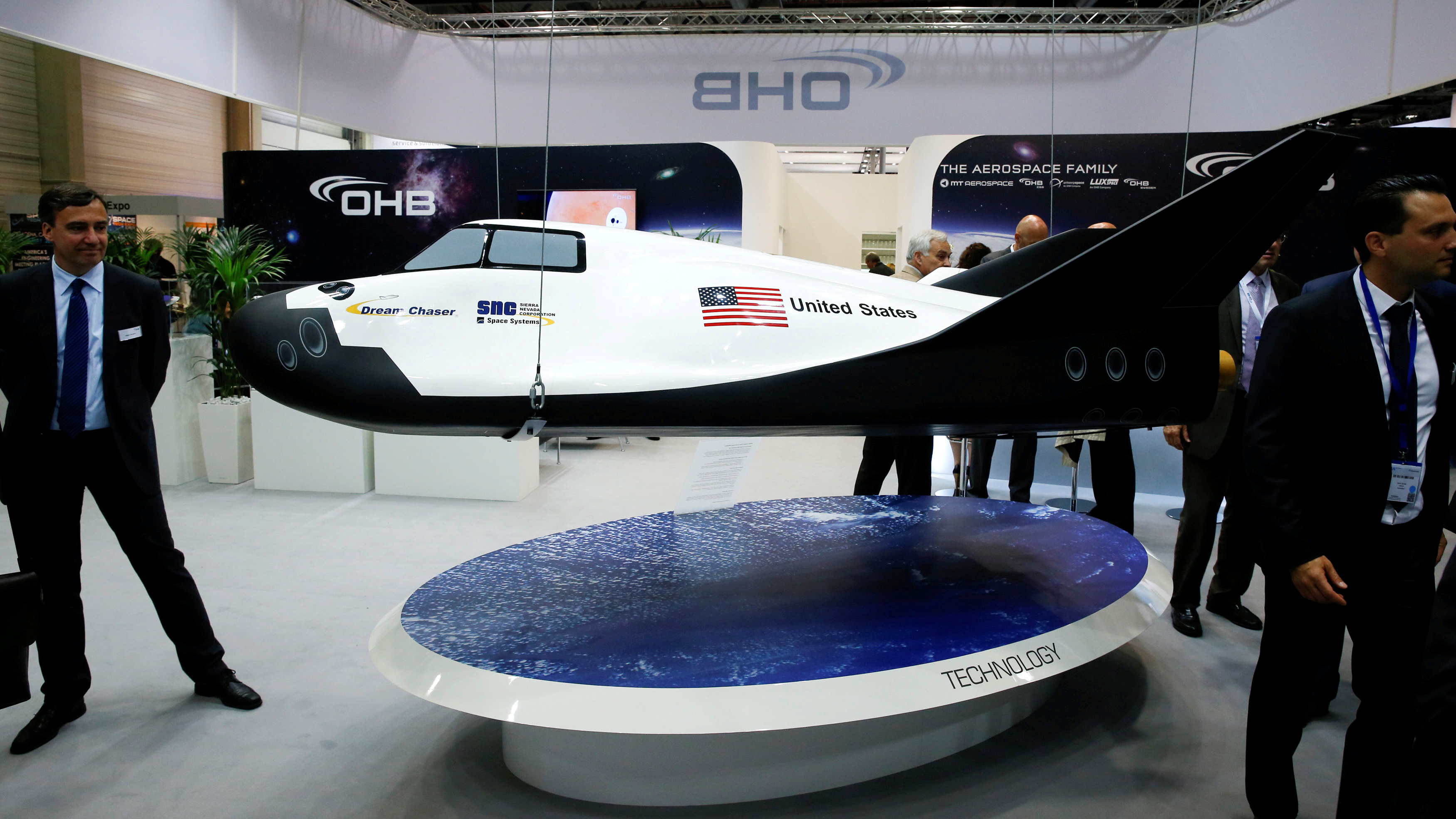 Visitors look at the Dream Chaser Cargo System developed by Sierra Nevada Corporation (SNC) Space Systems at the ILA Berlin Air Show in Schoenefeld, south of Berlin, Germany