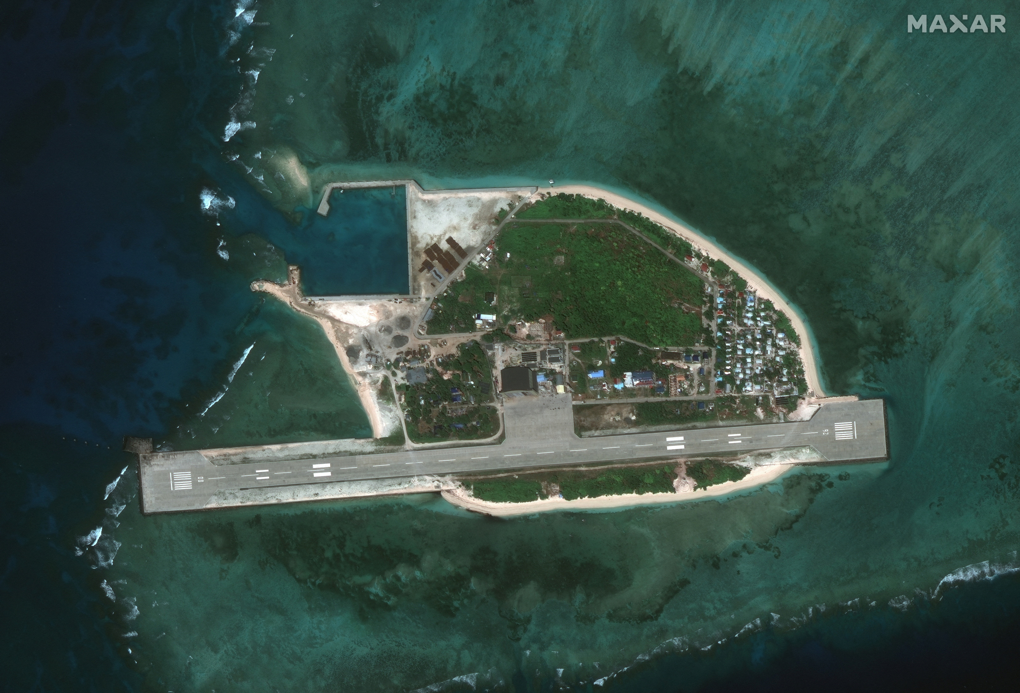 A satellite image appears to show an overview of Thitu Island and a fishing fleet, in the South China Sea