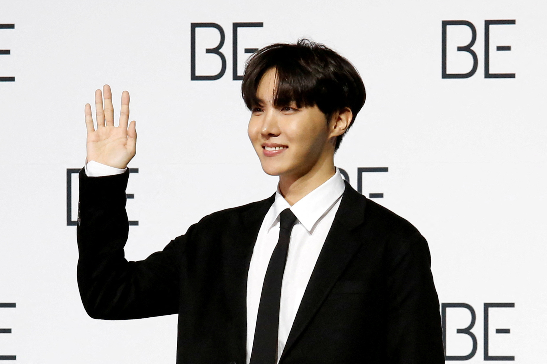 K-pop boy band BTS member J-hope poses for photograph during a news conference promoting their new album 