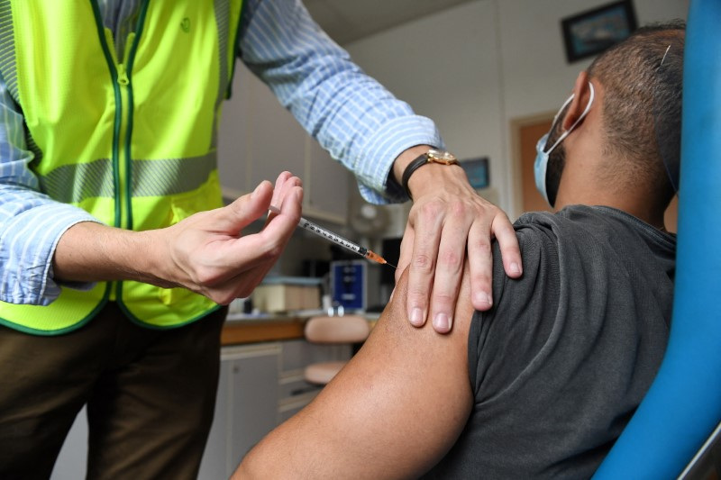 A man receives a dose of the mpox vaccine at the Edison municipal vaccination centre in Paris