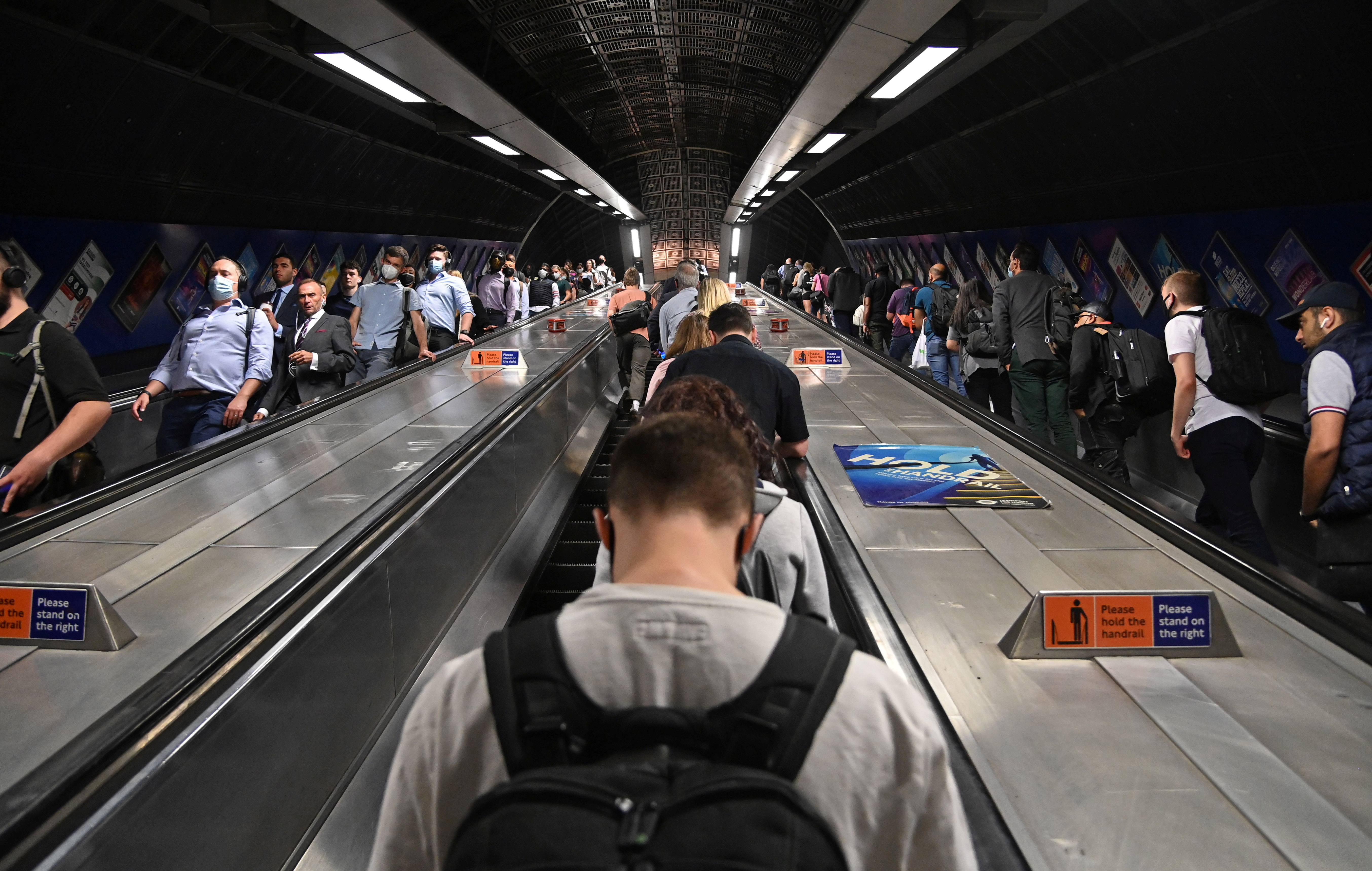 Workers travel through London Bridge rail and underground station during the morning rush hour in London