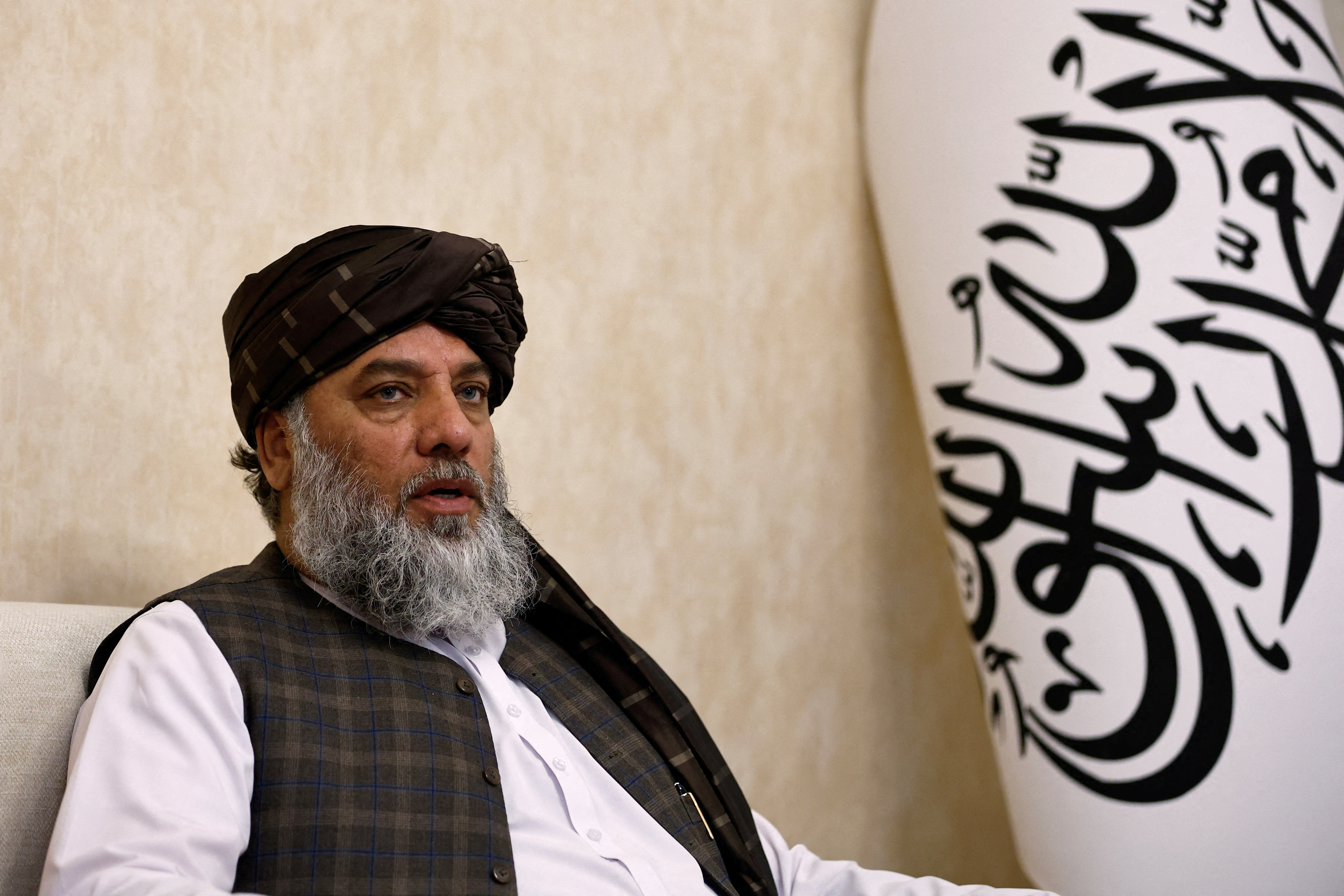 Taliban's acting commerce minister Haji Nooruddin Azizi speaks during an interview with Reuters, at the Embassy of Afghanistan in Beijing